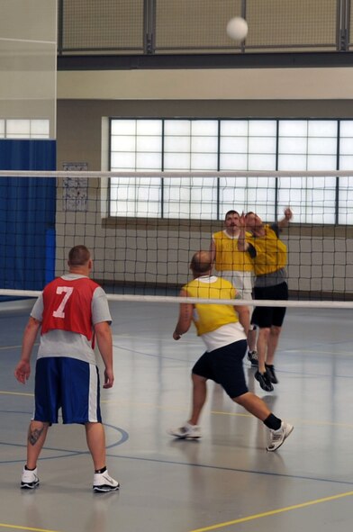 Airmen from the 26th Operational Weather Squadron spike the ball during a game of volleyball against Airmen from the 2nd Comptroller Squadron at the fitness center on Barksdale Air Force Base, La., March 30. The 26 OWS won two out of the three games, making them the victors. (U.S. Air Force photo/Senior Airman Brittany Y. Bateman)(RELEASED)