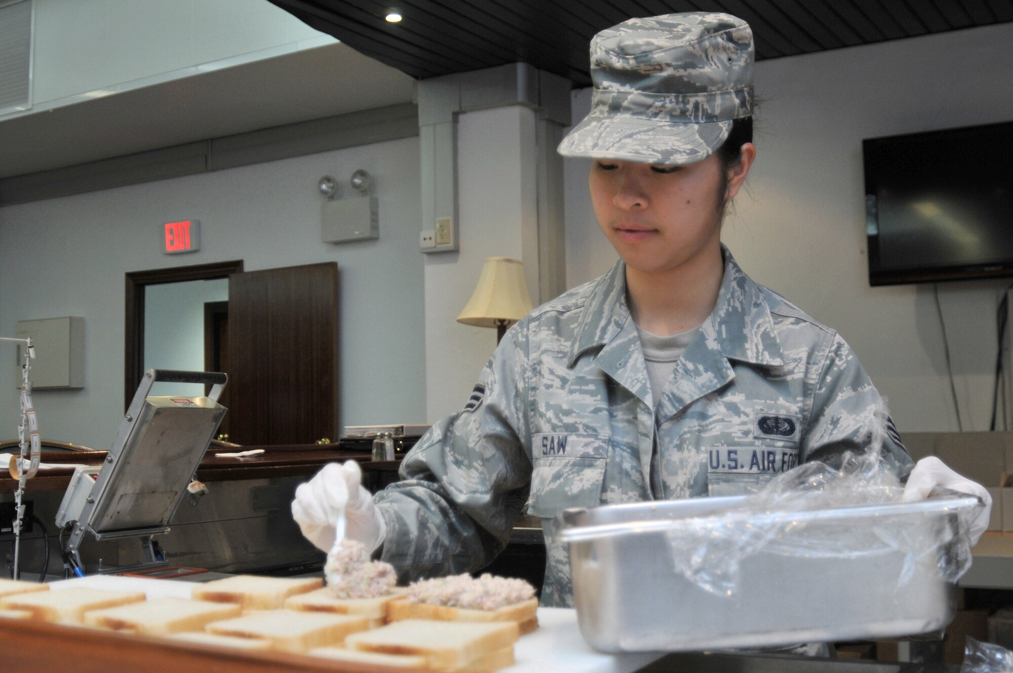 Senior Airman Kaythi Saw prepares sandwiches for flight meals March 30, 2011, at Spangdahlem Air Base, Germany, in support of Joint Task Force Odyssey Dawn. Saw is a flight kitchen assistant assigned to Spangdahlem Air Base, Germany. (U.S. Air Force photo/Senior Airman David Dobrydney)