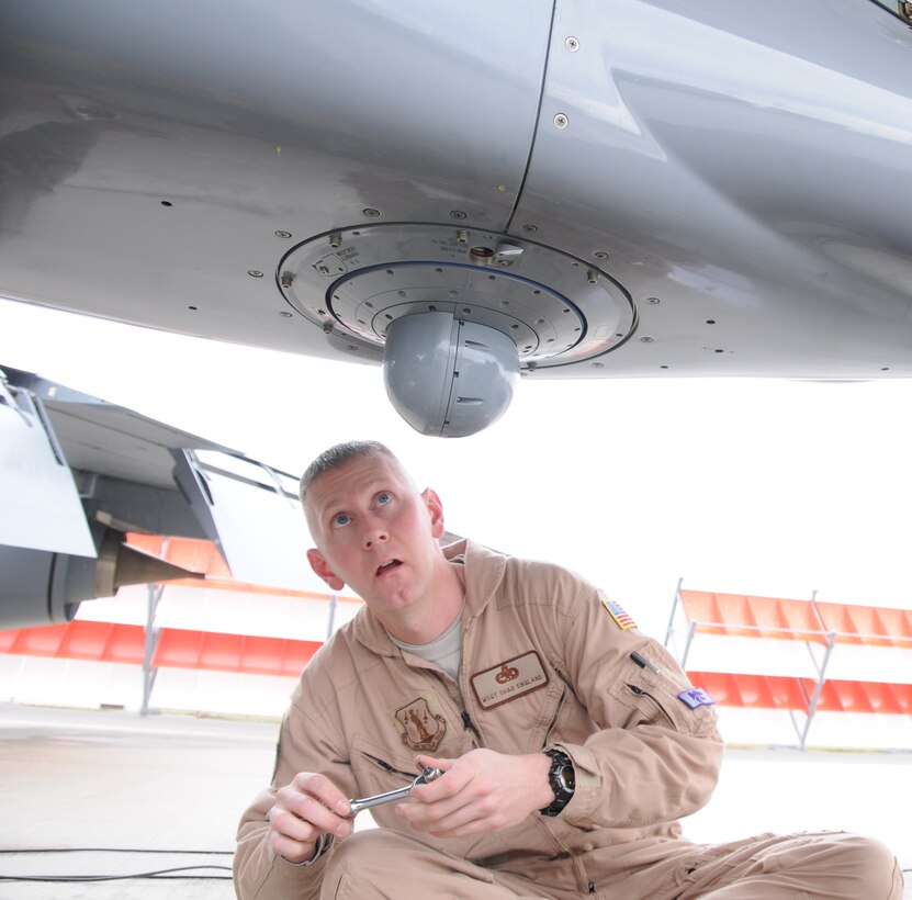 Master Sgt. Shad England examines the missile countermeasure system mounted on a 190th ARW KC-135 between aero medical evacuation missions in Afghanistan. (photo by Master Sgt. Allen Pickert)