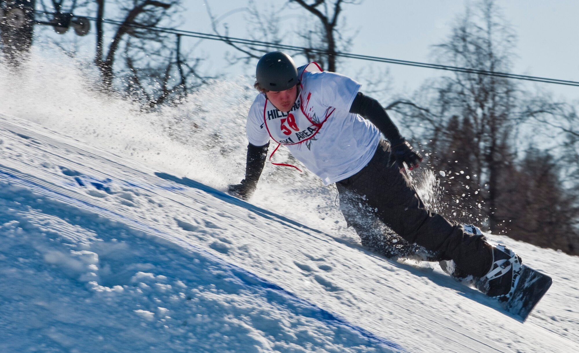 JOINT BASE ELMENDORF-RICHARDSON, Alaska -- Kevin Stumm attempts to avoid wiping out after landing during Hillberg's Annual Melt Down Big Air Competition March 26. During the last few days of the season, various competitions such as the big air competition and annual "Slush Cup" were held. (U.S. Air Force photo by Senior Airman Christopher Gross)