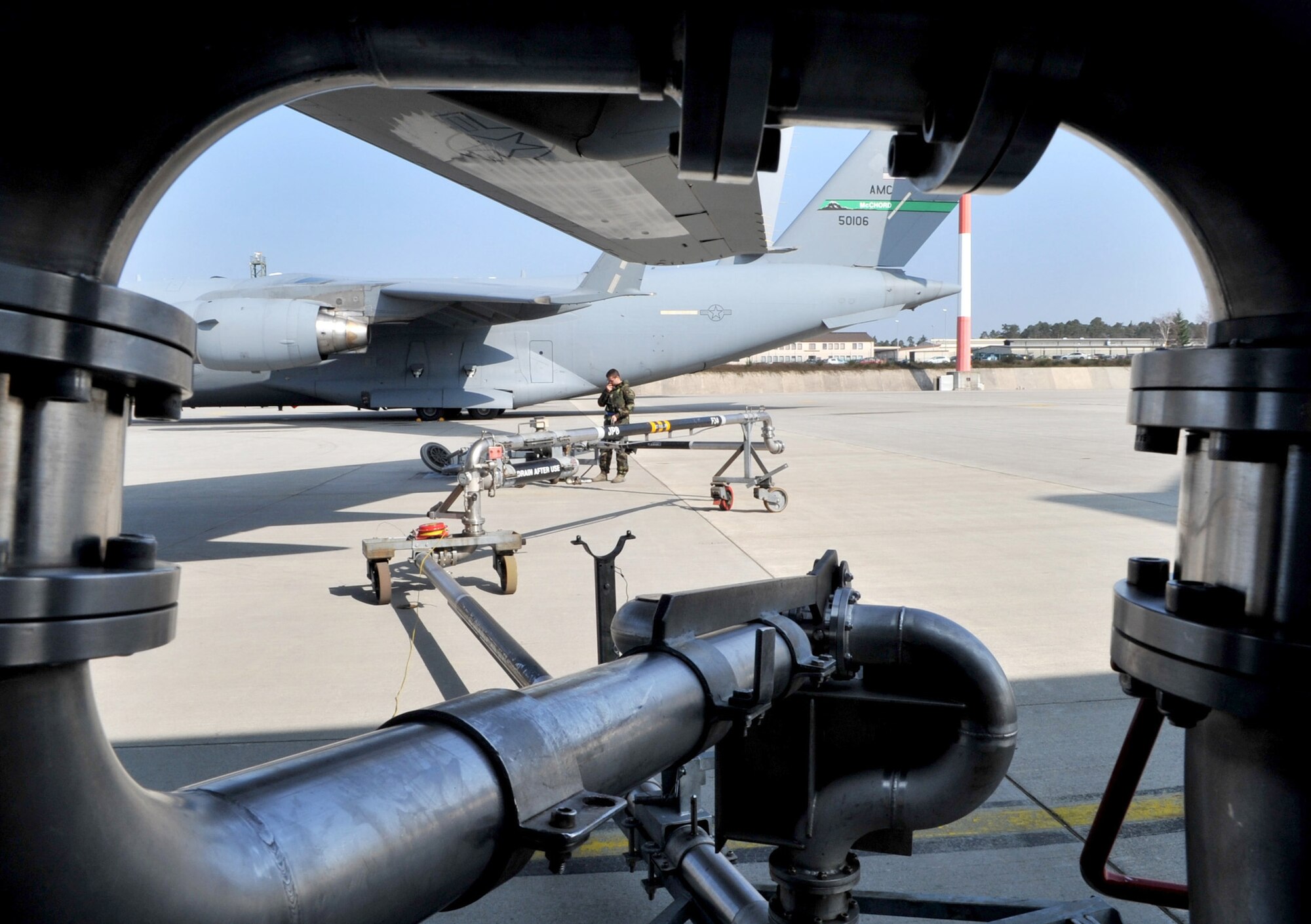 Airman 1st Class Jason O'Connor radios the controller after setting up to refuel a C-17 Globemaster III March 29, 2011, at Ramstein Air Base, Germany, in support of Operation Odyssey Dawn. O'Connor is a fuels distribution operator assigned to the 86th Logistics Readiness Squadron. (U.S. Air Force photo/Senior Airman Caleb Pierce)