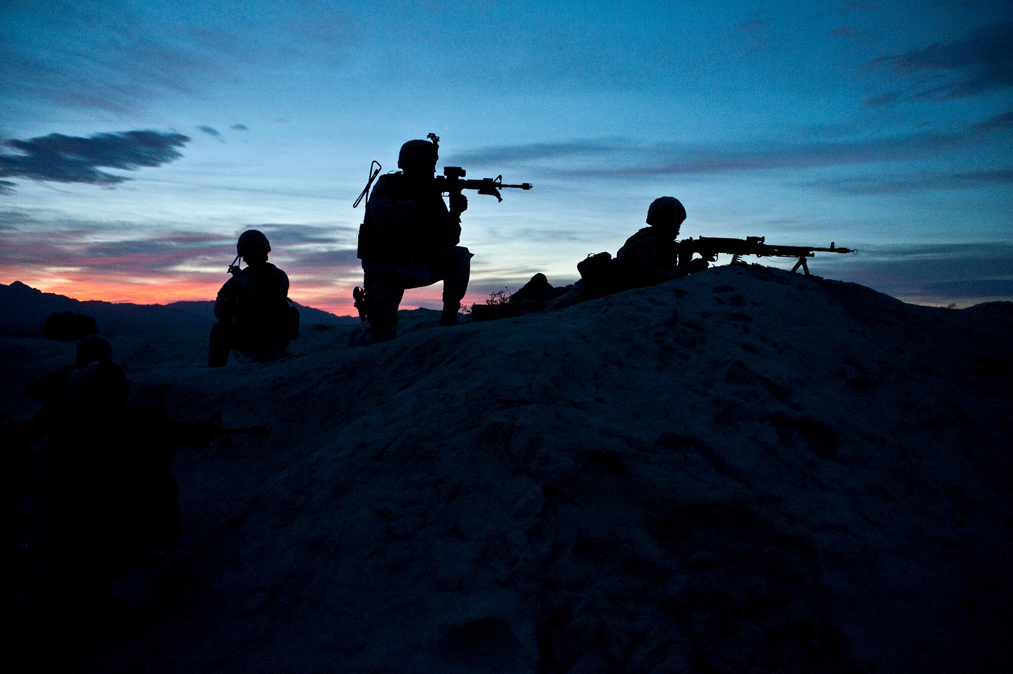 A group of U.S. and British airmen move into position to provide cover fire during a field training exercise March 16, 2011, as part of Desert Eagle on the Nevada Test and Training Range. (U.S. Air Force photo/Tech. Sgt. Michael R. Holzworth)
