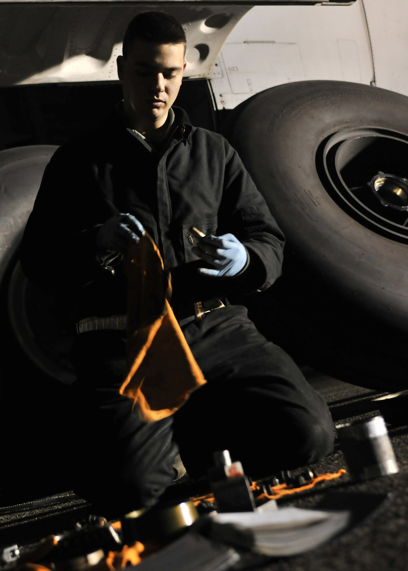 YOKOTA AIR BASE, Japan -- Airman 1st Class Stephen Tessier, 374th Aircraft Maintenance Squadron crew chief, prepares tools to be used for preventive maintenance on a C-130 Hercules here March 31, 2011. The Kewanee, Ill., native is stationed in Japan and is currently supporting Operation Tomodachi, which kicked off at the request of the Government of Japan to support humanitarian relief efforts for those affected by the earthquake and tsunami disaster March 11. Crews at Yokota are working around the clock to ensure continual support to Japanese disaster relief efforts. (U.S. Air Force photo/Airman 1st Class Andrea Salazar)