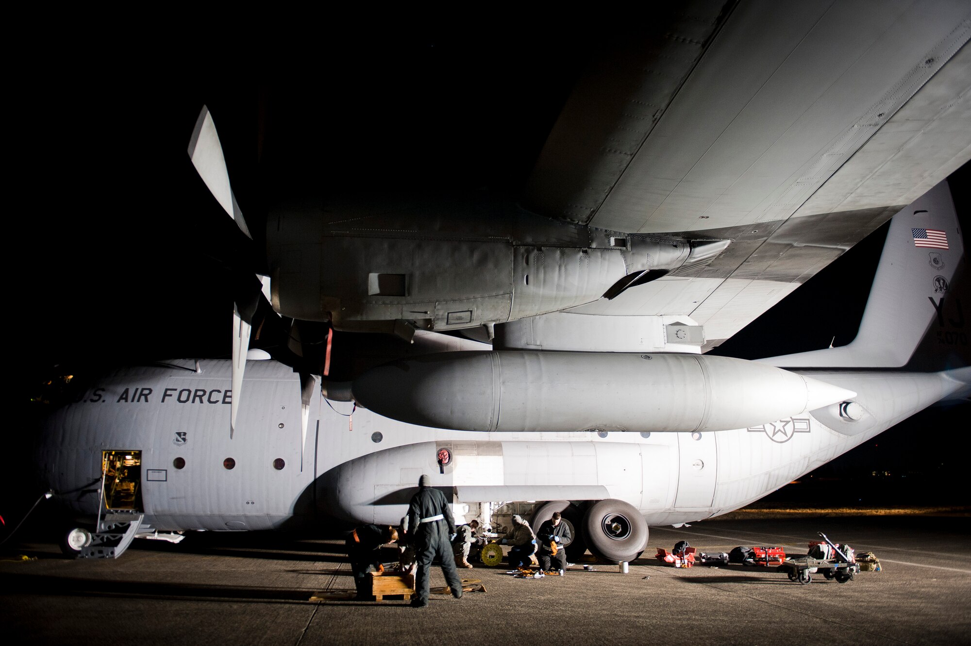 YOKOTA AIR BASE, Japan -- Crew chiefs from the 374th Aircraft Maintenance Squadron, work on brakes on a C-130 Hercules here March 31.  As part of Operation Tomodachi, the U.S. military has mobilized its humanitarian airlift capabilities to support emergency relief efforts throughout quake and tsunami affected regions of Japan that are. Yokota?s location and tactical airlift capability makes the base a key element of these efforts. (U.S. Air Force photo/Staff Sgt. Chad C. Strohmeyer)