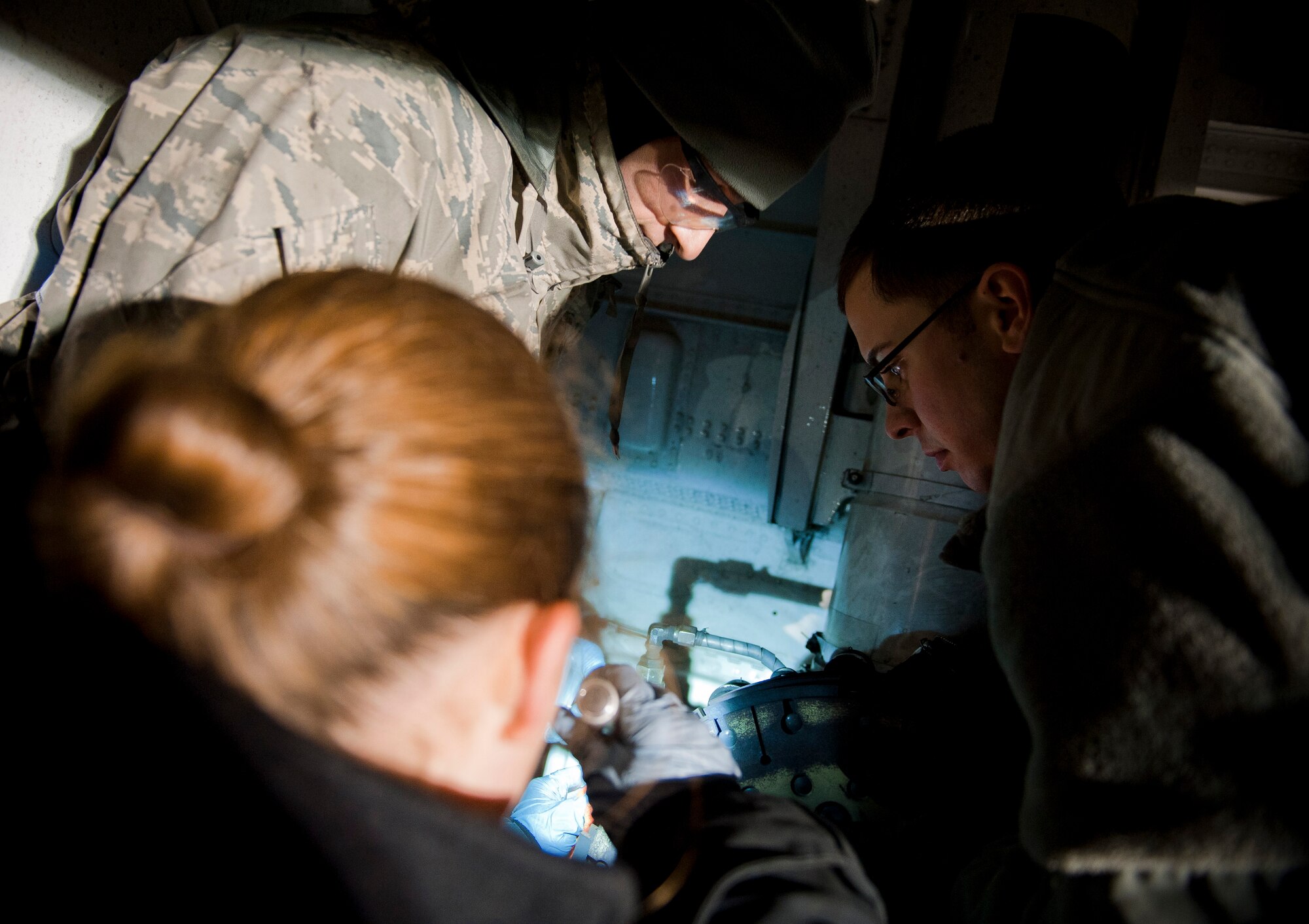 YOKOTA AIR BASE, Japan -- Crew chiefs from the 374th Maintenance Squadron, work on brakes on a C-130 Hercules here March 31.  Crews at Yokota are working around the clock to ensure continual support to Japanese disaster relief efforts. (U.S. Air Force photo/Staff Sgt. Chad C. Strohmeyer)