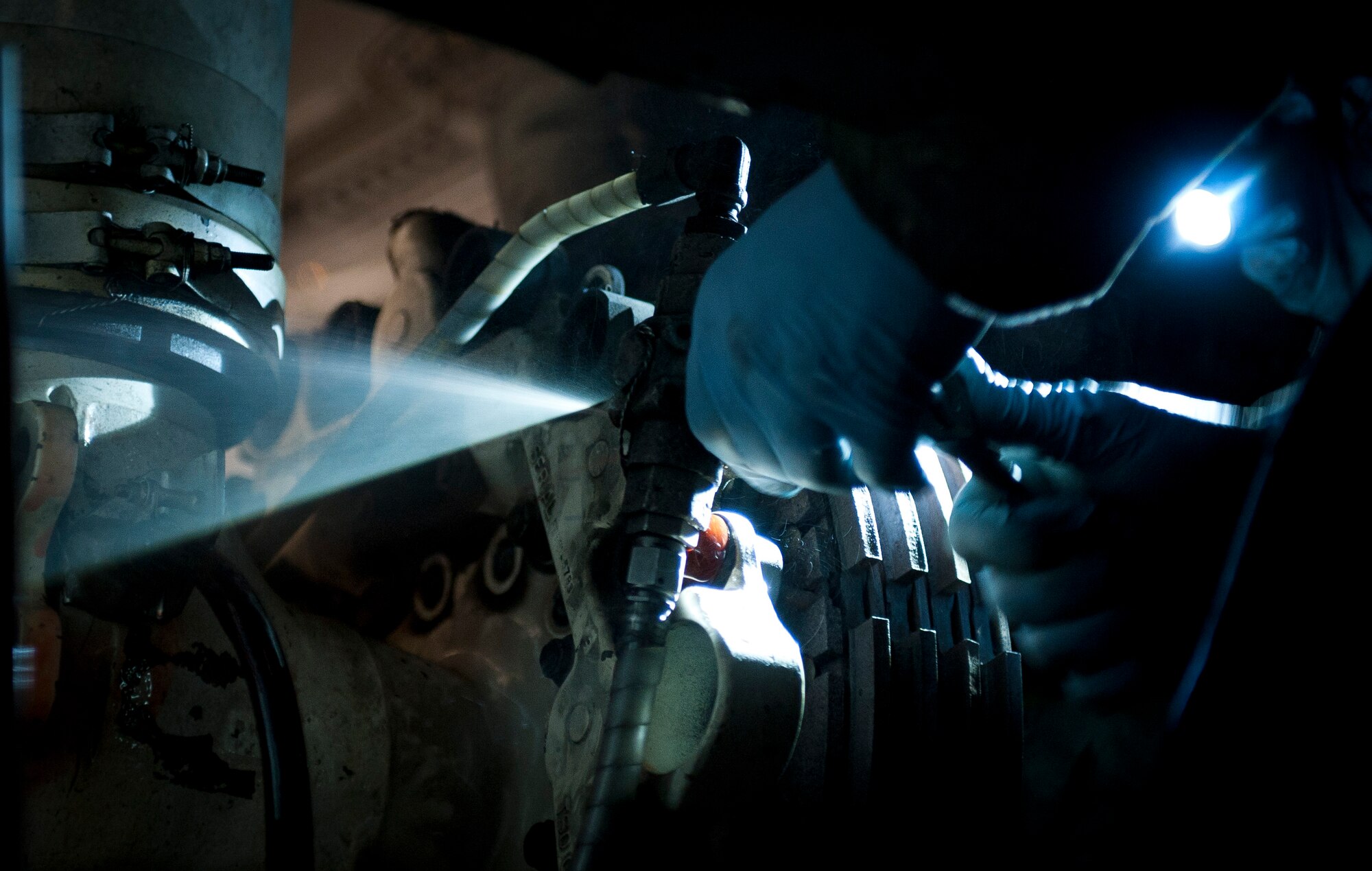 YOKOTA AIR BASE, Japan -- Crew chiefs from the 374th Maintenance Squadron, work on brakes on a C-130 Hercules here March 31.  Crews at Yokota are working around the clock to ensure continual support to Japanese disaster relief efforts. (U.S. Air Force photo/Staff Sgt. Chad C. Strohmeyer)