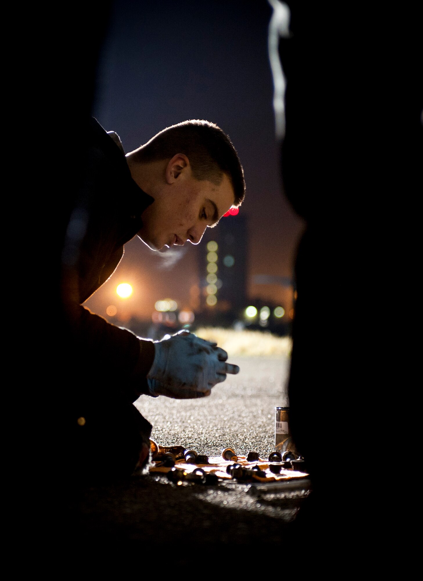 YOKOTA AIR BASE, Japan -- Airman 1st Class Stephen Tessier, 374th Maintenance Squadron crew chief, applies grease to bolts for a C-130 Hercules here March 31.  As part of Operation Tomodachi, the U.S. military has mobilized its humanitarian airlift capabilities to support emergency relief efforts throughout quake and tsunami affected regions of Japan that are. Yokota's location and tactical airlift capability makes the base a key element of these efforts. (U.S. Air Force photo/Staff Sgt. Chad C. Strohmeyer)