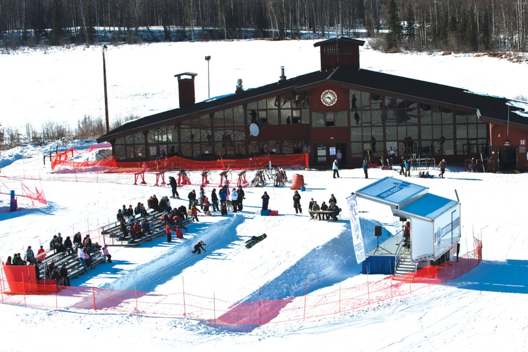 A crowd sits at the bottom outside of Hillberg Ski Lodge March 26, watching  ontestants perform jumps in the big air completion during Hillberg’s Annual Meltdown weekend. During the last few days of the season, various competitions such as the big air competition and annual Slush Cup were held. (U.S. Air Force photo/ SRA Christopher Gross)