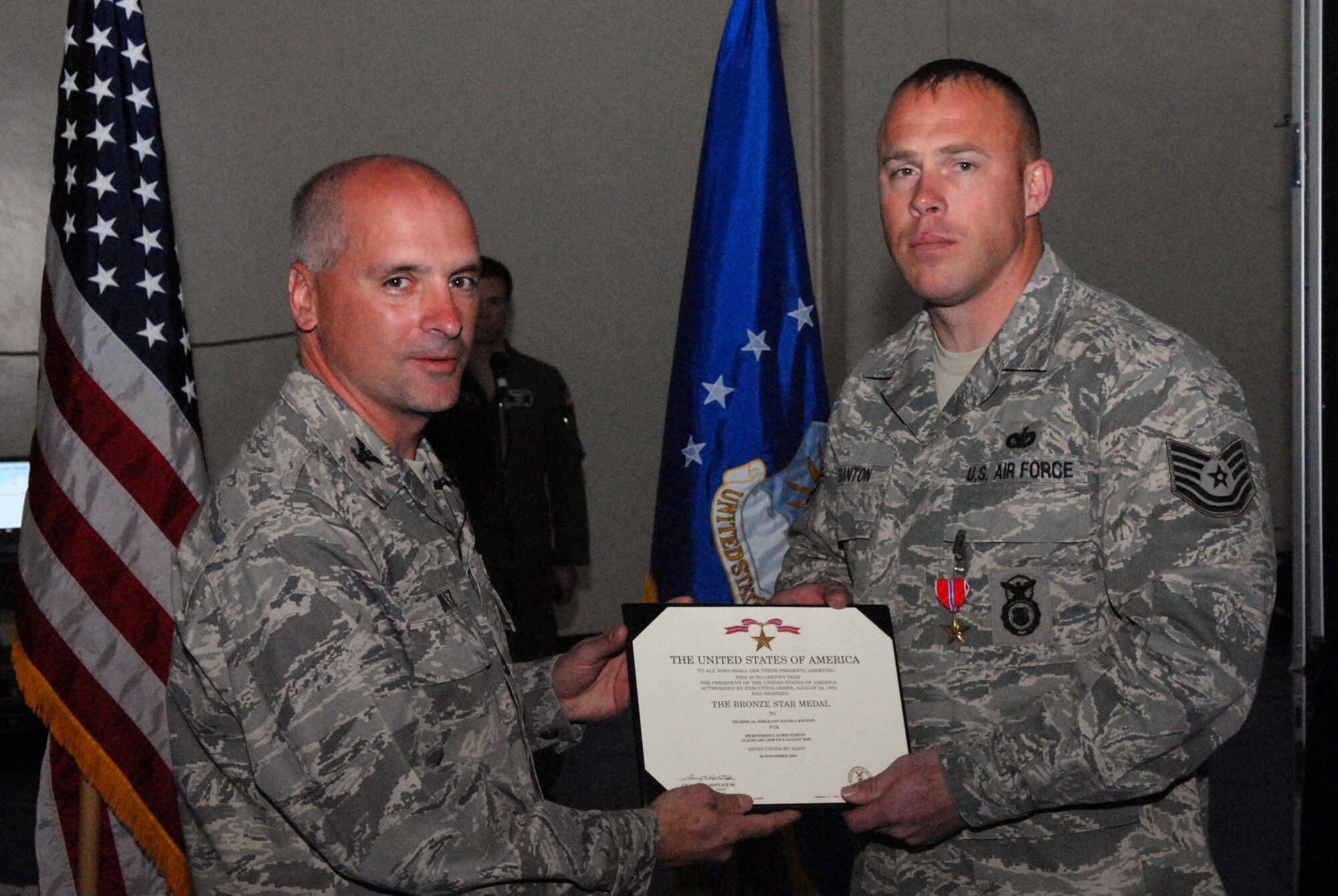 VANDENBERG AIR FORCE BASE, Calif. - Tech. Sgt. David Banton, 30th Security Forces Squadron, is presented the Bronze Star medal by Col. Richard Boltz, 30th Space Wing commander, during a commander's call held at the fitness center here on Wednesday, March 30, 2011. Sergeant Banton received the Bronze Star for his exemplary leadership, personal endeavor, and devotion to duty while engaged in ground combat against an enemy of the United States at Joint Base Balad, Iraq, from 23 January 2010 to 6 August 2010. (U.S. Air Force photo/ Jerry E. Clemens, Jr.)