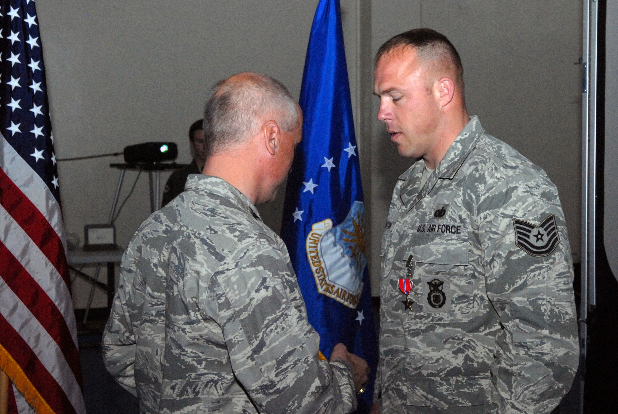 VANDENBERG AIR FORCE BASE, Calif. - Tech. Sgt. David Banton, 30th Security Forces Squadron, is presented the Bronze Star medal by Col. Richard Boltz, 30th Space Wing commander, during a commander's call held at the fitness center here on Wednesday, March 30, 2011. Sergeant Banton received the Bronze Star for his exemplary leadership, personal endeavor, and devotion to duty while engaged in ground combat against an enemy of the United States at Joint Base Balad, Iraq, from 23 January 2010 to 6 August 2010. (U.S. Air Force photo/ Jerry E. Clemens, Jr.)