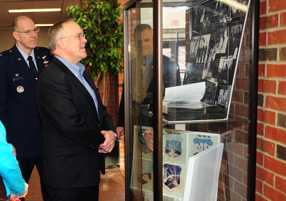 SCOTT AIR FORCE BASE, Ill. -- Bruce Grant (right), son of Lt. Gen. Harold W. Grant, and Air Force Network Integration Center Commander Col. Curt Piontkowsky look through the cases of historical photos and artifacts located in the atrium of the building dedicated in the late general’s honor. (U.S. Air Force photo by SSgt Teresa Jennings)
