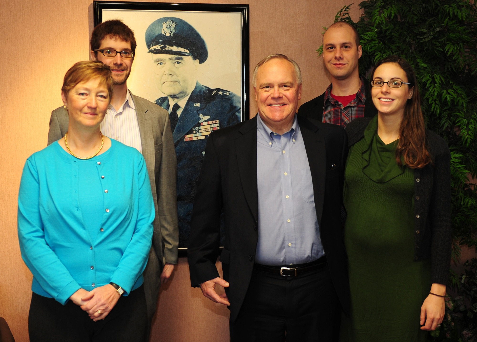 SCOTT AIR FORCE BASE, Ill. – Family members of the late Lt. Gen. Harold W. Grant pose near a portrait of the general at the entrance of the building named in his honor.  From left, Corinne Grant, daughter-in-law; Andrew Grant, grandson; Bruce Grant, son; Christopher Grant, grandson; Katie Grant, granddaughter. (U.S. Air Force photo by SSgt Teresa Jennings)