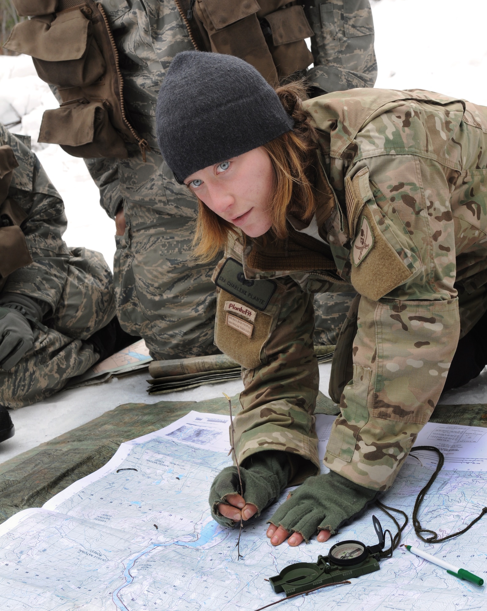 Senior Airman Charlene Plante, 22nd Training Squadron, Survival Evasion Resistance Escape specialist, teaches her students triangulation March 13, 2011 in Colville National Forest, Wash., The purpose of this block of training is to teach students how to pinpoint their location using a map, compass and sticks. (U.S. Air Force Photo/Tech. Sgt. JT May III)