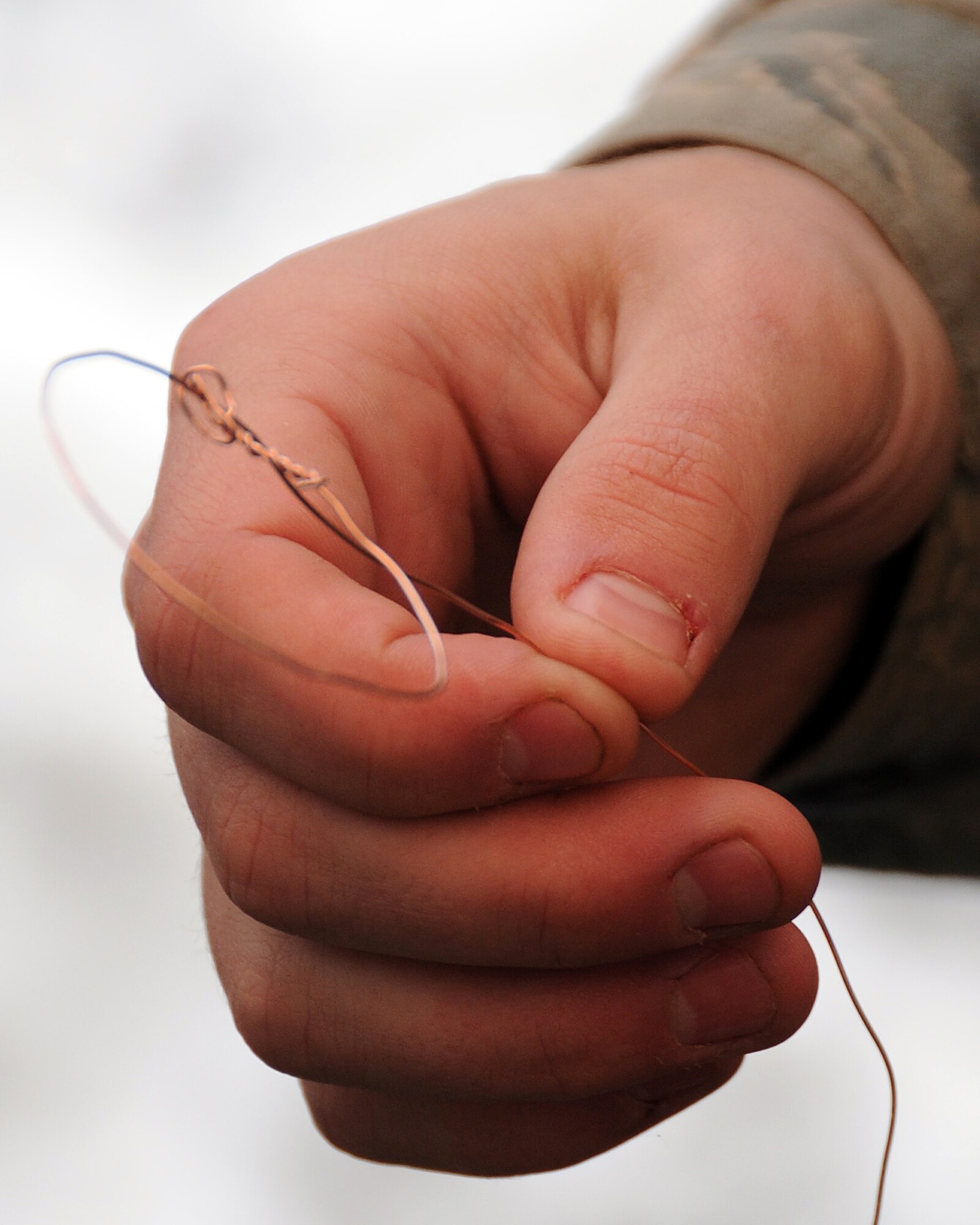 A student holds up a completed snare made from copper wire March 13, 2011 during Survival Evasion Resistance Escape training located in Colville National Forest, Wash. The students are taught this technique to provide another resource to procure food in case in a survival situation. (U.S. Air Force Photo/Tech. Sgt. JT May III)