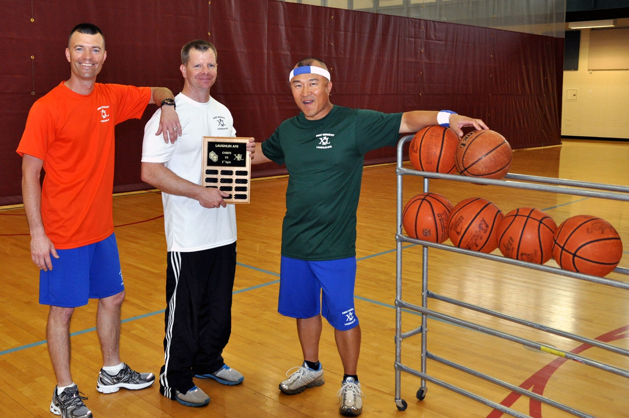 LAUGHLIN AIR FORCE BASE, Texas - - Master Sergeants Nick Kurpier, 47th Medical Group first sergeant, Jeff McGaffin, 47th Operations Group first sergeant and James Escher,  47th Security Forces Squadron first sergeant, pose together after winning the First Sergeants versus Chiefs basketball shoot-out at Laughlin’s Losano Fitness Center, March 29. The competition allowed each shooter two minutes to make as many shots as possible, which ended in an 84 to 69 victory for the first sergeants. (U.S. Air Force photo by Senior Airman Scott Saldukas) )