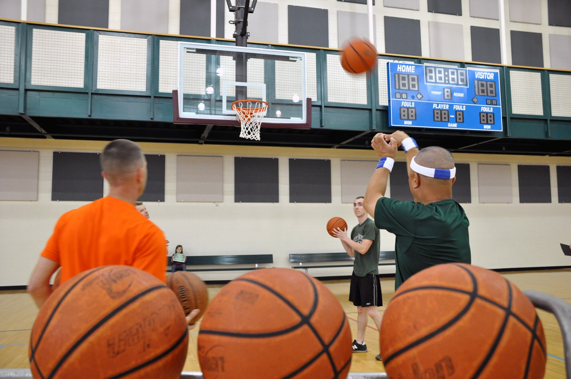 LAUGHLIN AIR FORCE BASE, Texas - - Master Sgt. James Escher, 47th Security Forces Squadron first sergeant, shoots and reloads free throw attempts during First Sergeants versus Chiefs basketball shoot-out at Laughlin’s Losano Fitness Center, March 29. The competition allowed each shooter two minutes to make as many shots as possible, which ended in an 84 to 69 victory for the first sergeants. (U.S. Air Force photo by Senior Airman Scott Saldukas)