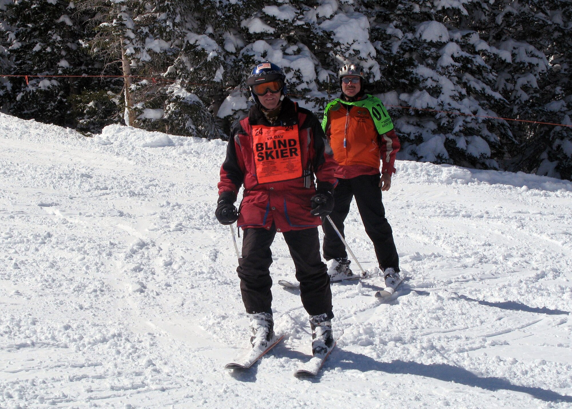 Elden Miller, a former Army sergeant blinded during a truck explosion at Fort Carson, Colo., finds the "Miracle on the Mountain" while blazing independently down the wide-open spaces of Colorado's Snowmass Mountain at the National Disabled Veterans Winter Sports Clinic, March 29, 2011. Accompanying him is volunteer ski instructor Jerry Miserandino. (DOD photo/Donna Miles) 