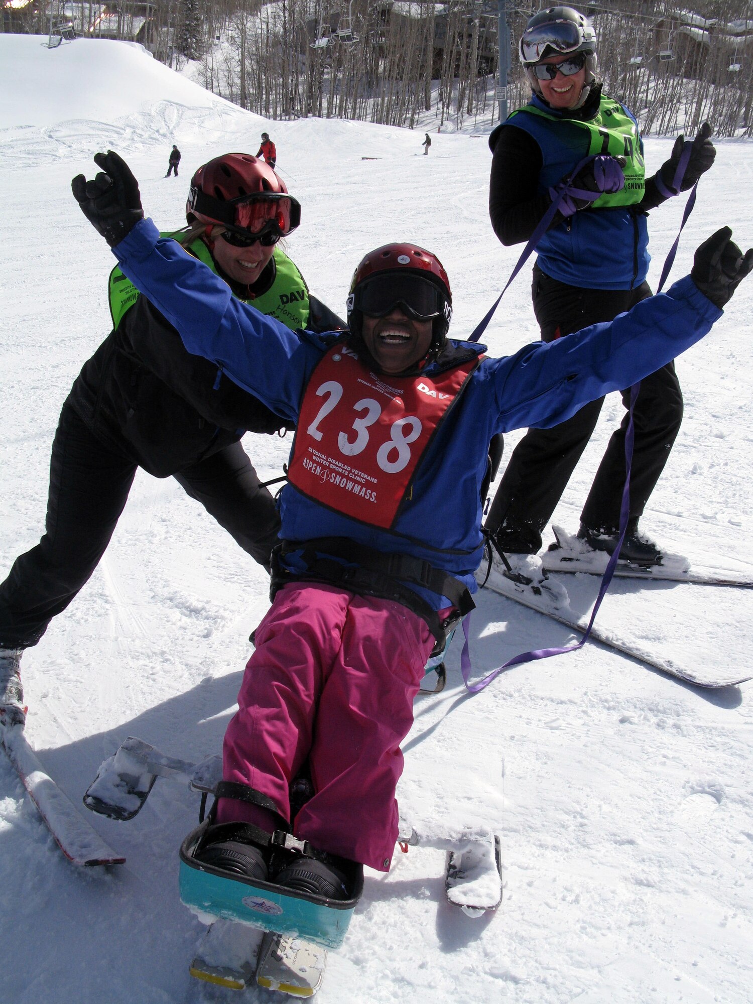 Former Air Force Senior Airman Sheila James, center, celebrates after conquering Snowmass Mountain and discovering the "Miracle on the Mountain" during the 25th National Disabled Veterans Winter Sports Clinic at Colorado's Snowmass Mountain, March 29, 2011. Sharing her breakthrough are volunteer ski instructors Andrea Hanson and Richelle Dube. (DOD photo/Donna Miles)