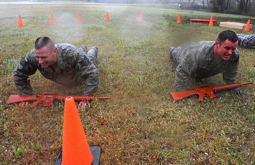 SEYMOUR JOHNSON AIR FORCE BASE, N.C. - Tech. Sgt. Randall Mello and Staff Sgt. Mark Price do push-ups during the Emergency Service Team try-outs March 30, 2011. Sergeants Mello and Price are members of the 4th Security Forces Squadron. (U.S. Air Forces photo/Senior Airman Gino Reyes)(Released)