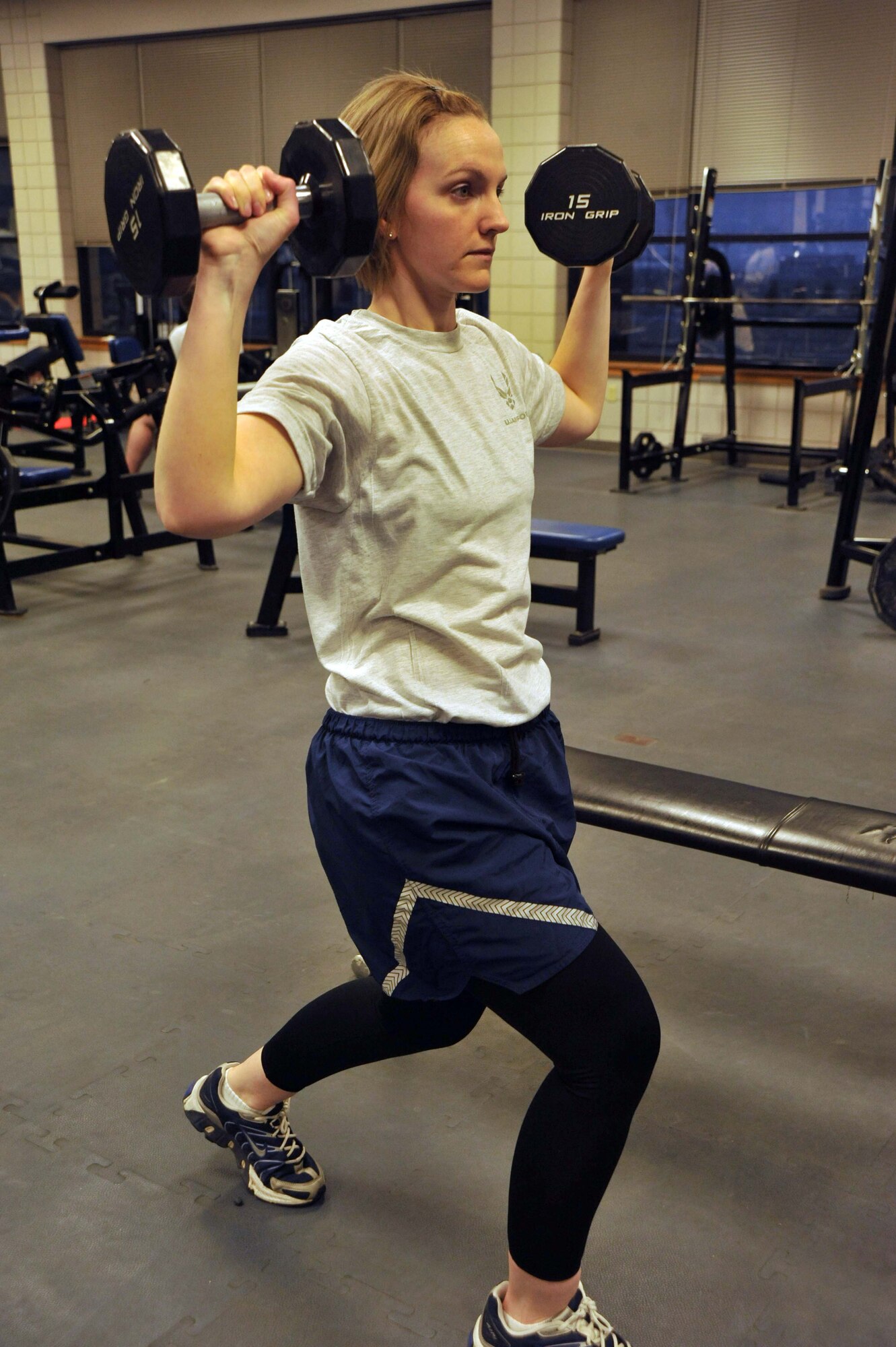 Tech. Sgt. Mary Nelson, 22nd Aeromedical Squadron Optometry Clinic NCOIC, performs lunges as part of her daily workout at the fitness center here March 31, 2011, McConnell Air Force Base, Kan.  After having her first child, Sergeant Nelson, who previously scored in the "Excellent" category on her physical fitness tests, had to rebuild her core muscles to maintain this precedence.  (U.S. Air Force photo/Senior Airman Abigail Klein)