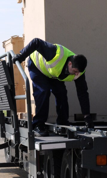110323-F-BX362-060 - RAF MILDENHALL, England (March 23, 2011) ?Members from the 100th Logistics Readiness Squadron cargo deployment function, prepare to unload a pallet on to a forklift to move the pallet into temporary storage here March 23, 2011. The pallet will be sent via air lift to support Joint Task Force Odyssey Dawn.  JTF Odyssey Dawn is the U.S. Africa Command task force established to provide operational and tactical command and control of U.S. military forces supporting the international response to the unrest in Libya and enforcement of United Nations Security Council Resolution (UNSCR) 1973. UNSCR 1973 authorizes "all necessary measures" to protect civilians in Libya under threat of attack by Gadhafi regime forces. JTF Odyssey Dawn is commanded by U.S. Navy Admiral Sam Locklear. (U.S. Air Force photo by Airman 1st Class Rachel Waller/Unreleased)