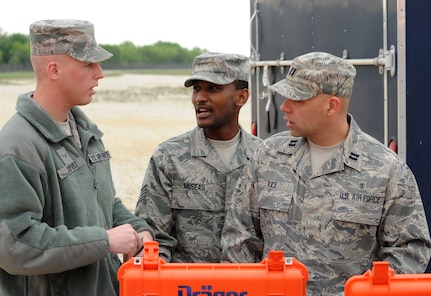First responders from the Air Education and Training Command 359 Aero Medical Squadron Randolph Air Force Base, Texas, Bio Environmental, Airman First Class Dustin Dayvolt (L), Staff Sergeant Jean Museau and Captain Richard Kice, prepare test equipment to determine what type of chemical/biological agent was released during Joint Base San Antonio exercise at Randolph Air Force Base Texas. March 30. (U.S. Air Force Photo By Don Lindsey)