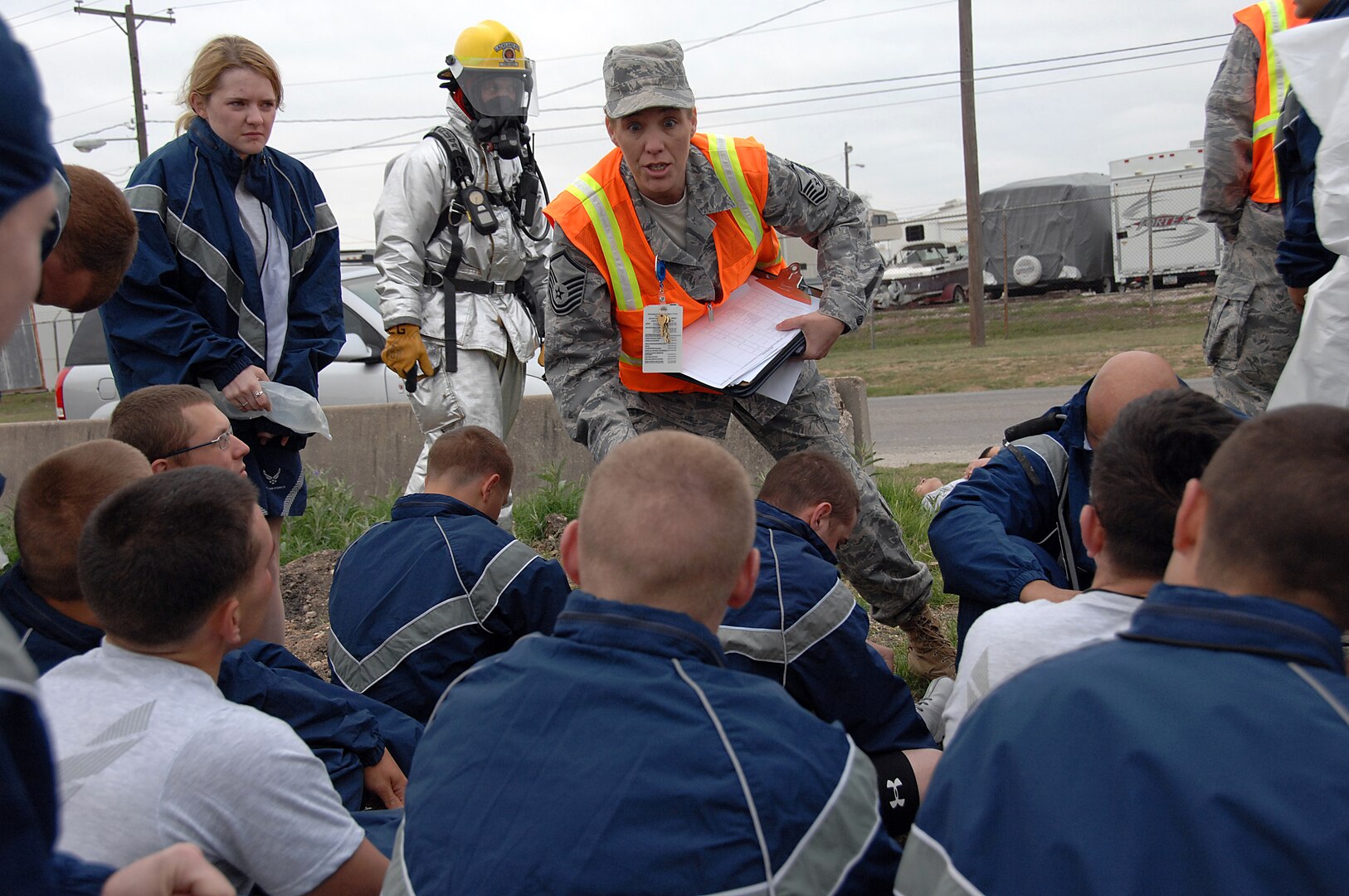 Master Sgt. Tammy Freeman (center) briefs exercise participants after a simulated chemical attack during an anti-terrorism exercise at Lackland Air Force Base on March 30.  The three-day exercise simulated the release of a nerve agent and involved units at Lackland, Randolph AFB and Ft. Sam Houston, Texas.  Sergeant Freeman is superintendent of the 59th Medical Wing Exercise Evaluation Team and Inspector General Office. (U.S. Air Force Photo/Staff Sgt. Josie Walck)