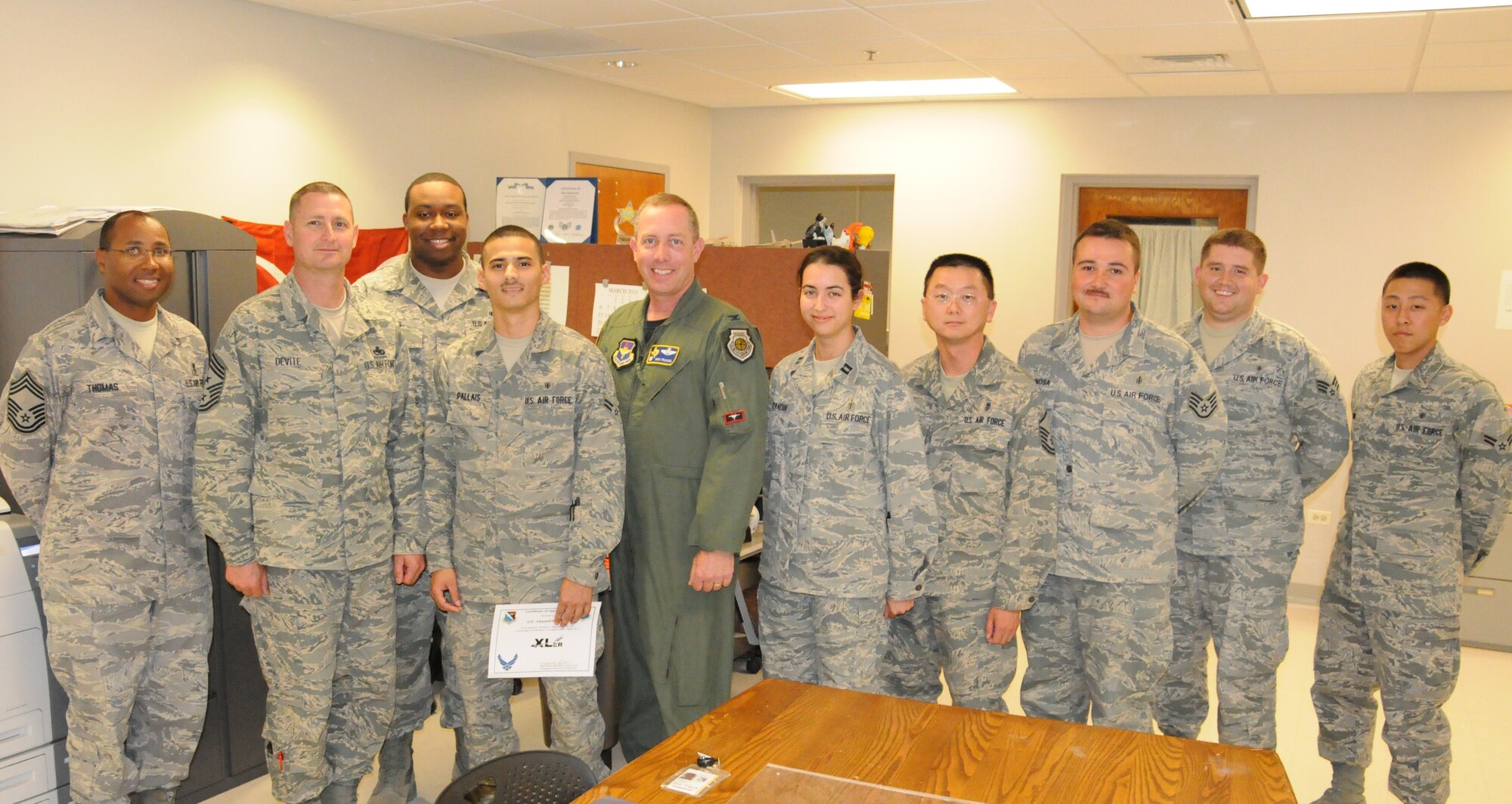 LAUGHLIN AIR FORCE BASE, Texas – Airman 1st Class Alejandro Pallais, 47th Medical Operations Squadron, poses with Col. Michael Frankel, 47th Flying Training Wing commander, Chief Master Sgt. Ray DeVite, 47th FTW command chief, and fellow members of his squadron after being presented the XLer of the Week award here March 23. The XLer is a weekly award chosen by wing leadership and given to those who consistently make outstanding contributions to Laughlin and their unit. (U.S. Air Force photo by Airman 1st Class Blake Mize)