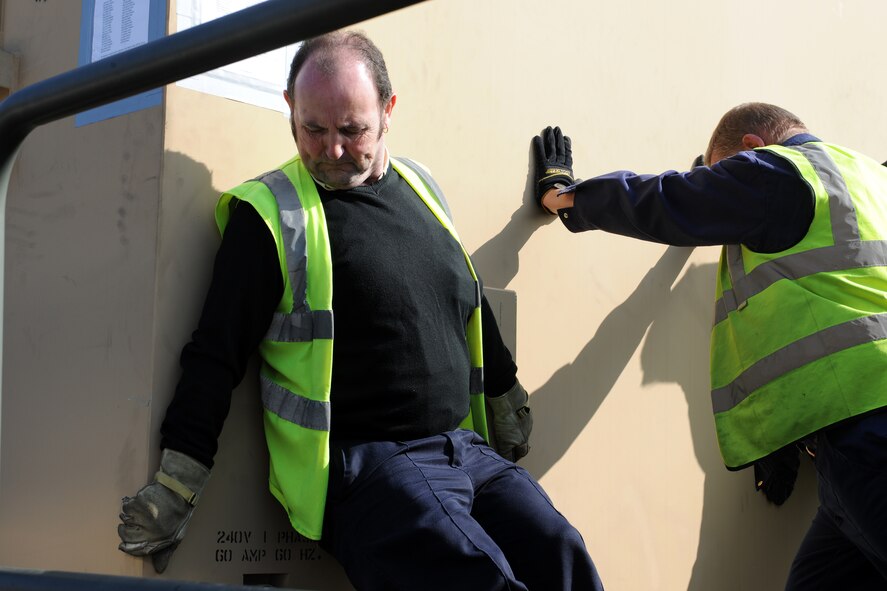 Members from the 100th Logistics Readiness Squadron cargo deployment function push a pallet into place here March 23, 2011. The pallet will be sent via airlift to support Joint Task Force Odyssey Dawn.  JTF Odyssey Dawn is the U.S. Africa Command task force established to provide operational and tactical command and control of U.S. military forces supporting the international response to the unrest in Libya and enforcement of United Nations Security Council Resolution (UNSCR) 1973. UNSCR 1973 authorizes "all necessary measures" to protect civilians in Libya under threat of attack by Gadhafi regime forces. JTF Odyssey Dawn is commanded by U.S. Navy Admiral Sam Locklear. (U.S. Air Force photo by Senior Airman Tabitha Lee/Released)