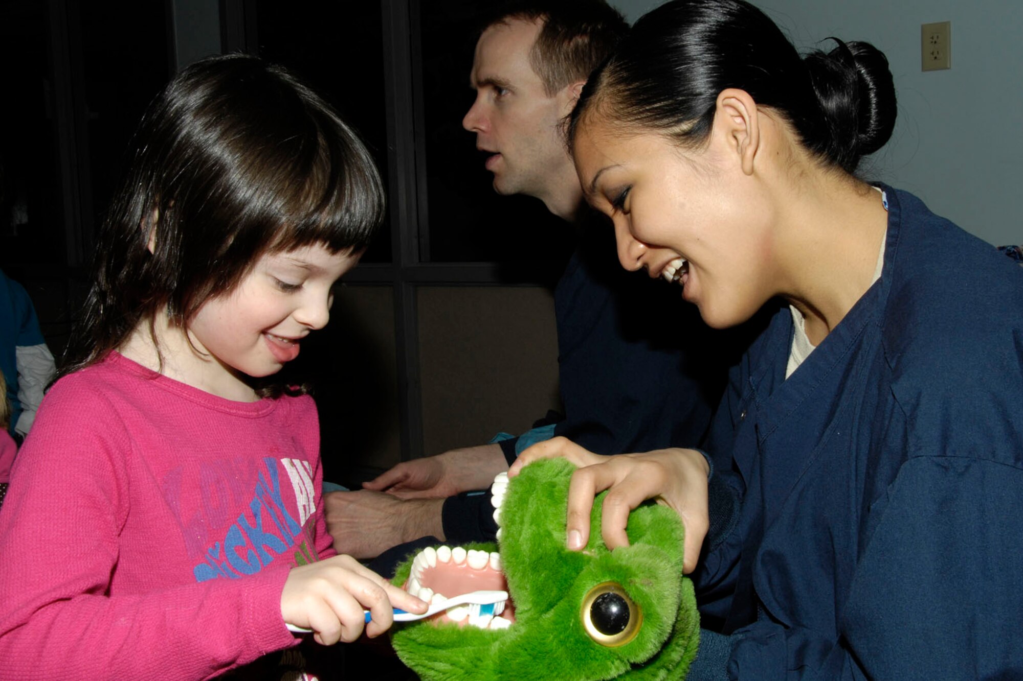 HANSCOM AIR FORCE BASE, Mass. – Airman 1st Class Joanna Fisher, from the 66th Medical Squadron’s Dental Flight, lets Angelique Troisi use a toothbrush to brush a stuffed animal’s teeth during a visit to the Child Development Center March 25. Dental Flight members visited the CDC to teach kids about good dental hygiene. (U.S. Air Force photo by Linda LaBonte Britt)