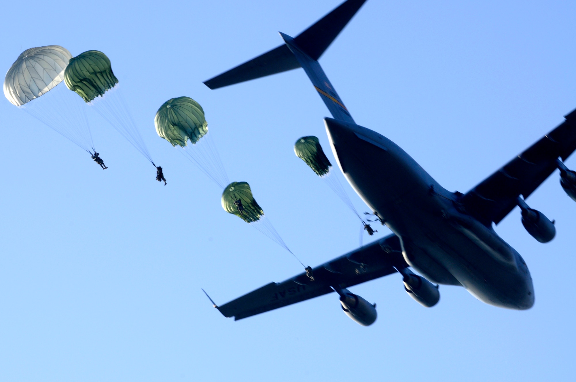 Airmen from the 8th Air Support Operations Squadron conduct combat jump operations from a C-17 Globemaster III during a joint coalition training exercise March 23. More than 1,400 personnel from the 173rd Airborne Brigade Combat Team, the 8th ASOS and Italian army paratroopers participated in the weeklong event.( U.S. Air Force photo/ Airman Briana N. Jones)