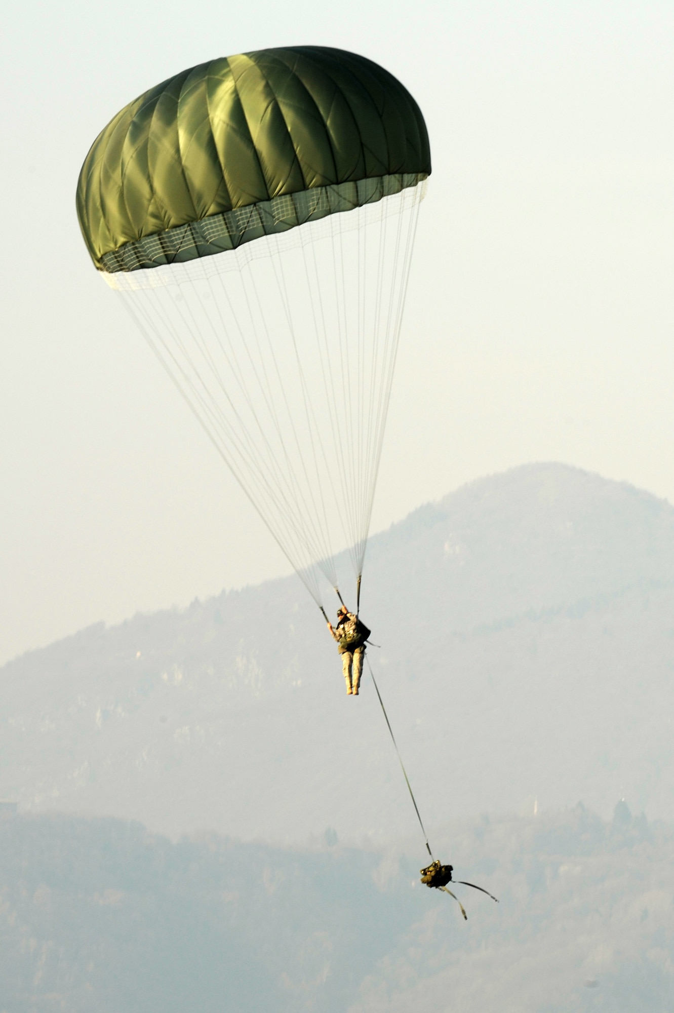 Tech. Sgt. Eduardo Ramos, 8th Air Support Operations Squadron joint terminal attack controller, parachutes down from a C-17 Globemaster III during a joint coalition training exercise March 23. More than 1,400 personnel from the U.S. Army 173rd Airborne Brigade Combat team, the 8th ASOS and Italian Army Paratroopers participated in the weeklong event.(U.S. Air Force photo/ Staff Sgt. Nadine Y. Barclay)