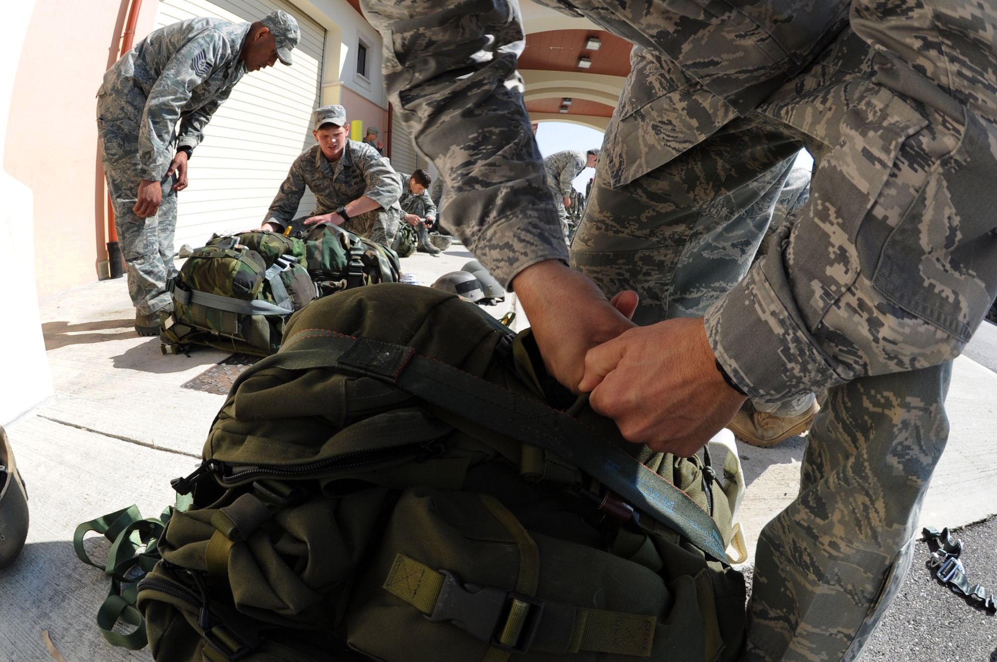 Joint terminal attack controllers from the 8th Air Support Operations Squadron pack ruck sacks to meet necessary weight requirements for combat jump operations training a joint coalition training exercise March 23. More than 1,400 personnel from the U.S. Army 173rd Airborne Brigade Combat team, the 8th ASOS and Italian army paratroopers participated in the weeklong event.(U.S. Air Force photo/ Staff Sgt. Nadine Y. Barclay)