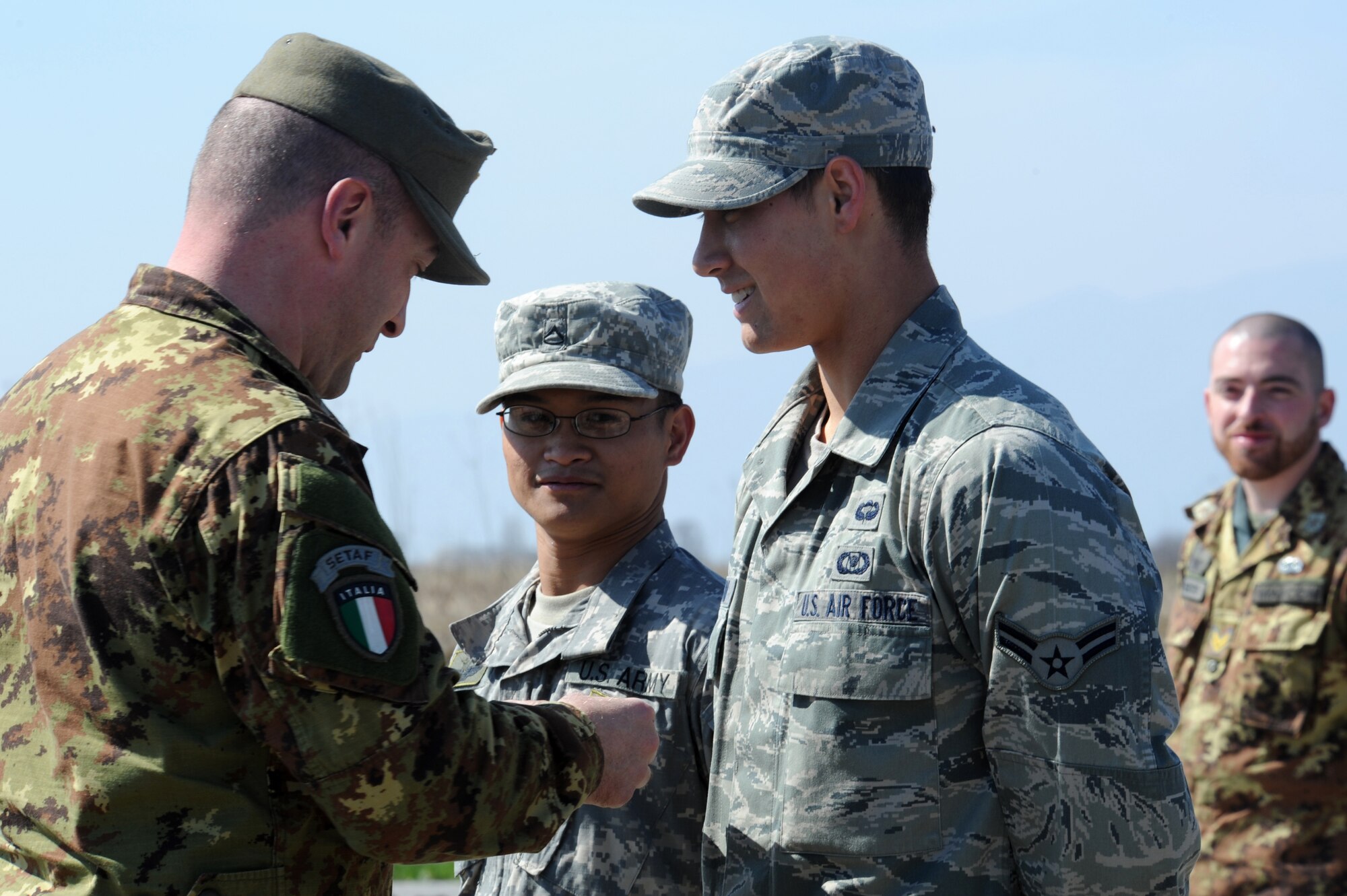 Airman 1st Class Craig Gabrielson, 8th Air Support Operation Squadron tactical air  was honored by Italian Army Sgt. 1st Class Luca Bertozzo during the ceremony when the paratrooper presented him with a set of wings.(U.S. Air Force photo/ Staff Sgt. Nadine Y. Barclay)