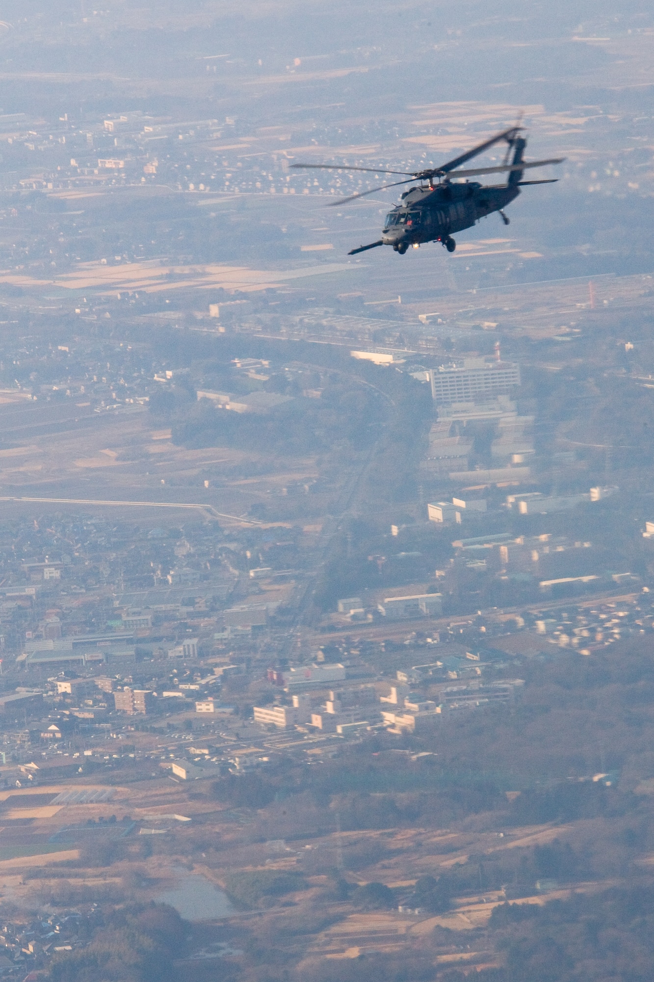 OVER IBARAKI PREFECTURE, Japan -- An HH-60G Pave Hawk flies to Fukushima prefecture to transport Australian volunteers and U.S. service members to assist with building a water pump system to transport fresh water into the Fukushima nuclear power plant instead of ocean water, March 28,2011. The U.S. military is fully committed to supporting the disaster response efforts of the Government of Japan and the Japan Self-Defense Force. (U.S. Air Force photo/Osakabe Yasuo)