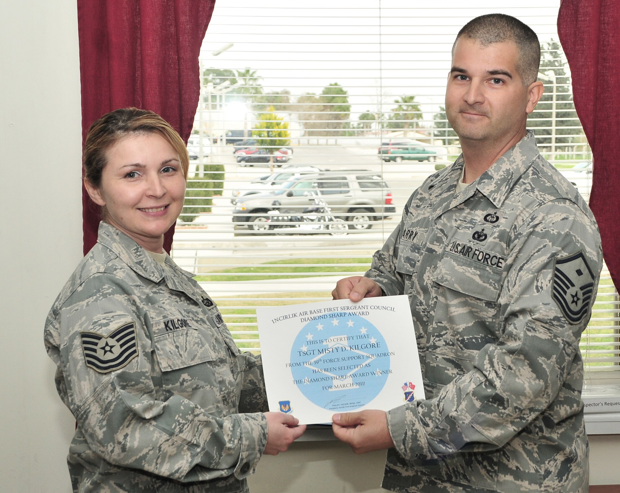 Tech. Sgt. Misty Kilgore, from the 39th Force Support Squadron, is presented the “Diamond Sharp” award by Master Sgt. Bill Barry, the 39th Force Support Squadron first sergeant, March 28, 2011, at Incirlik Air Base, Turkey. The “Diamond Sharp” award is presented by the Incirlik First Sergeants Council and recognizes Airmen who have distinguished themselves through outstanding professionalism, performance and the display of the Air Force core values. (U.S. Air Force photo by Staff Sgt. Alexandre Montes/Released)