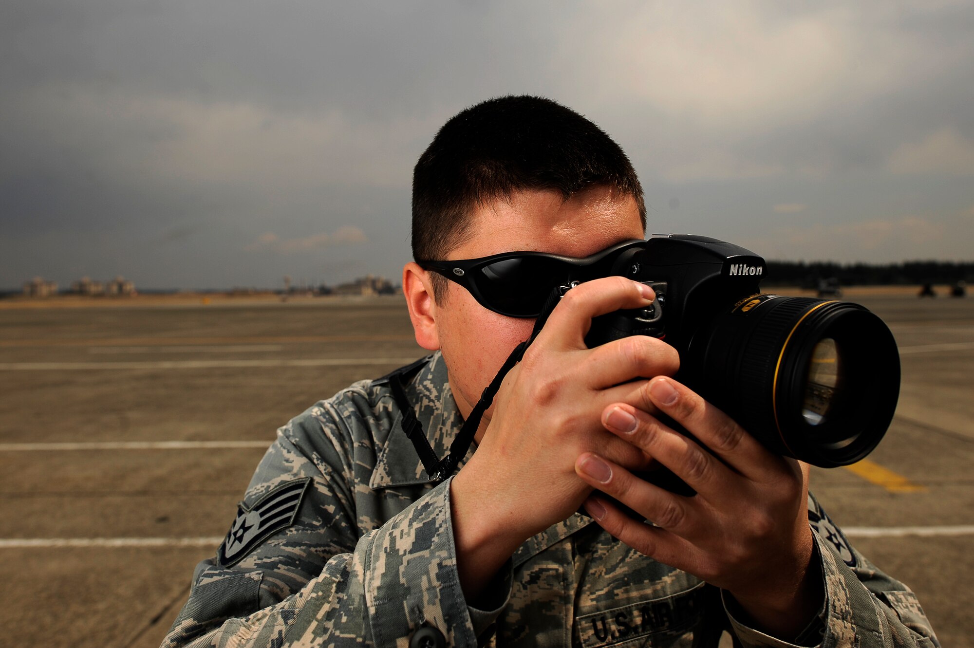 YOKOTA AIR BASE, Japan -- U.S. Air Force Staff Sgt. Samuel Morse, 374th Airlift Wing Public Affairs, takes photos on the flightline, March 29, 2011.  When asked about his roll in Operation Tomodachi Sergeant Morse said "Commanders regularly drill into us the importance of everyone for mission success, but it's not very often that the success is in our own backyard. We owe it to our host nation and to the honor of the United States, to work at the pinnacle of integrity, service and above all excellence."  Sergeant Morse, the NCO in charge of photography, hails from Danielson, Conn. (U.S. Air Force photo/Master Sgt. Jeromy K. Cross)






