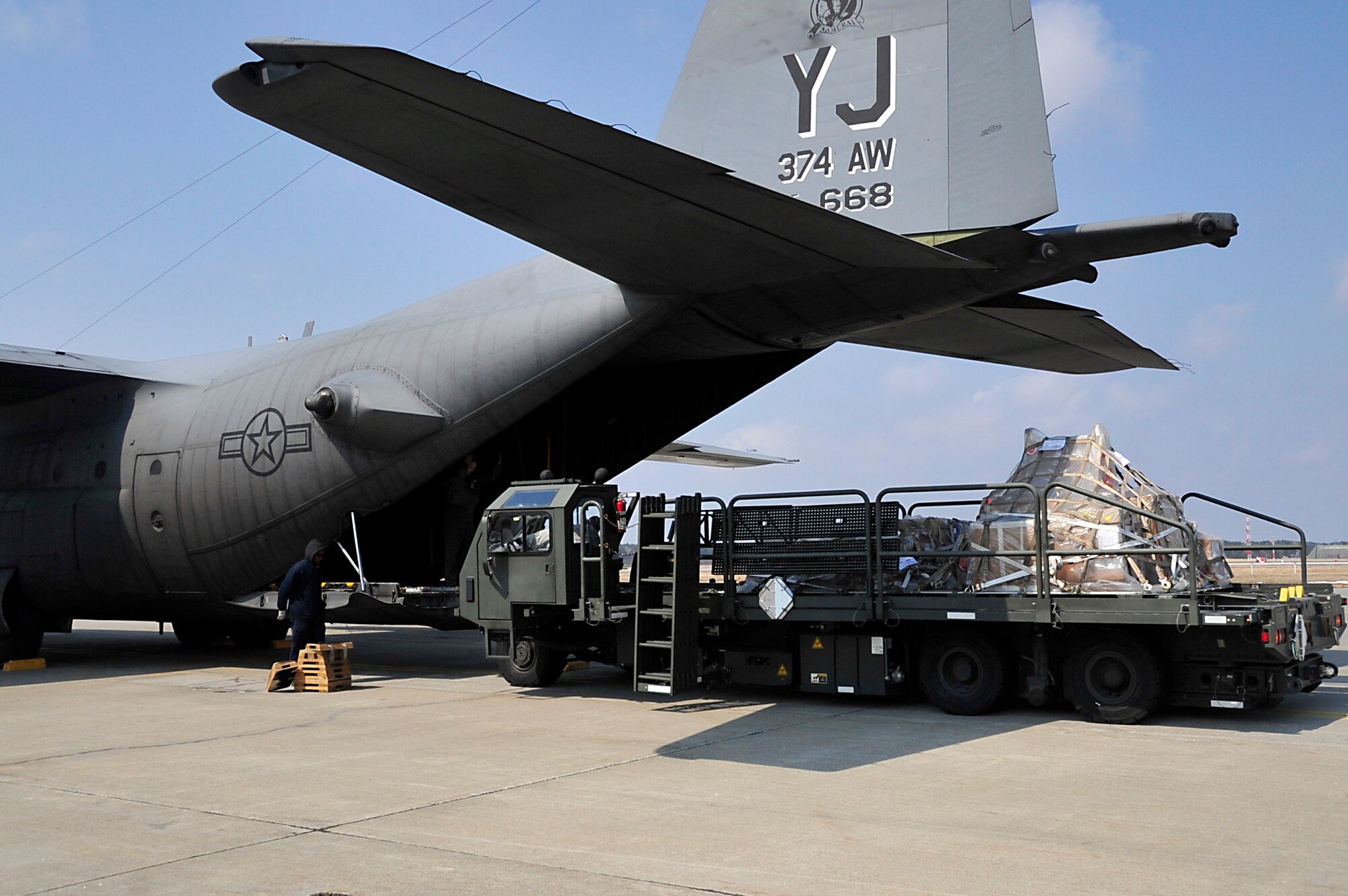 MISAWA AIR BASE, Japan -- Maytag employee prepare to upload cargo onto a C-130 Hercules March 31. Nearly one million pounds of cargo has been moved in and out of Misawa AB since Operation Tomodachi began. (U.S. Air Force photo by Staff Sgt. Marie Brown\Released)
