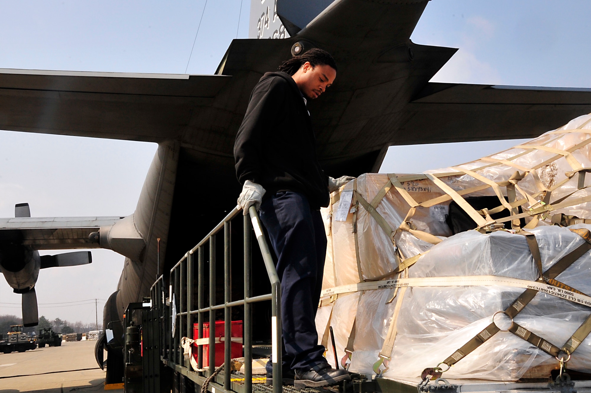 MISAWA AIR BASE, Japan -- Mr. Terrence Hughes, a Maytag employee, secures a pallet on a 40K loader March 31. Nearly one million pounds of cargo has been moved in and out of Misawa AB since Operation Tomodachi began. (U.S. Air Force photo by Staff Sgt. Marie Brown\Released)