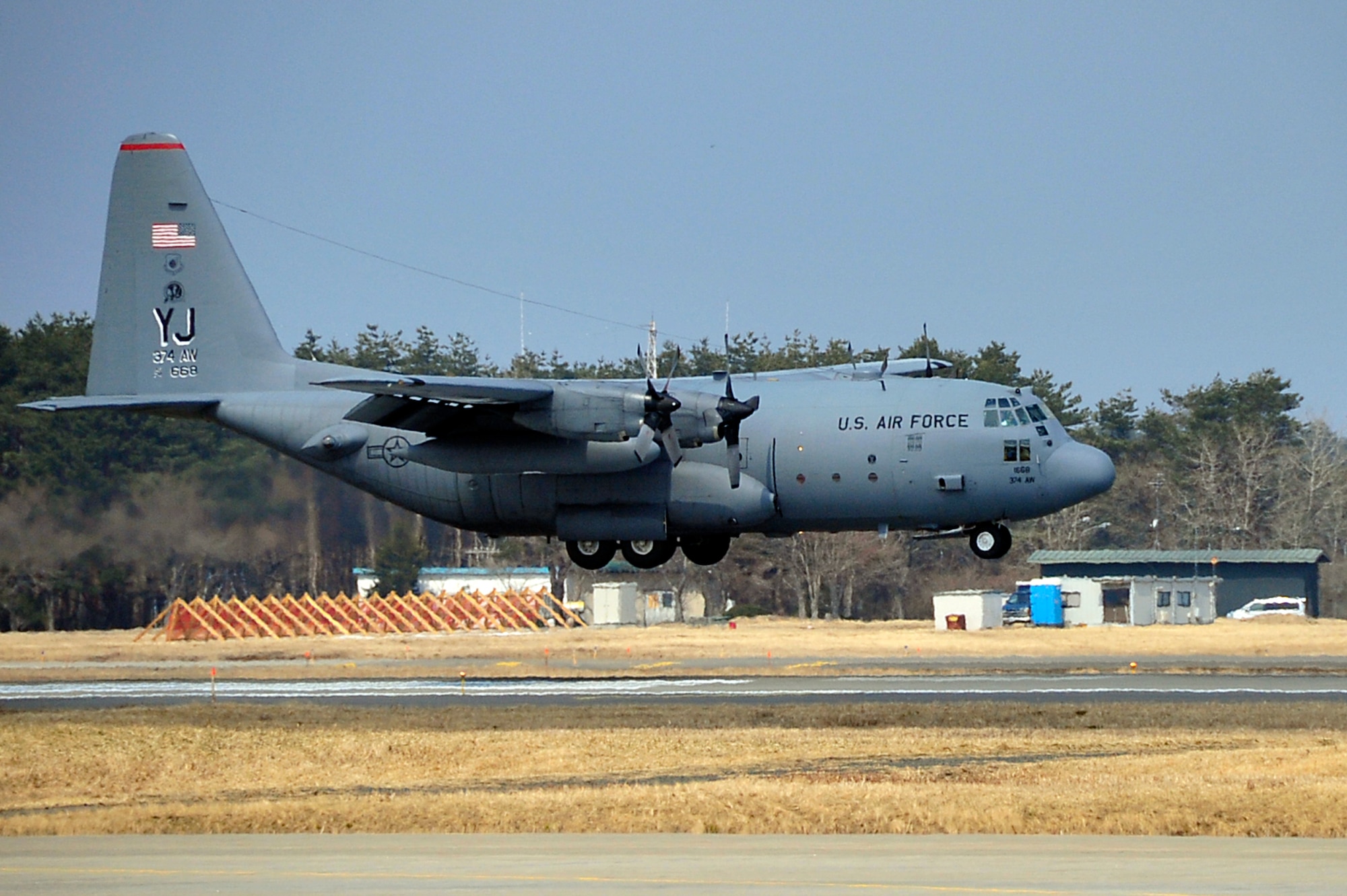 MISAWA AIR BASE, Japan -- A C-130 Hercules carrying supplies in support of Operation Tomodachi lands on the flightline March 31. Supplies and rescue workers have been arriving on a regular basis since March 13 after an earthquake shook Japan. (U.S. Air Force photo by Staff Sgt. Marie Brown\Released)