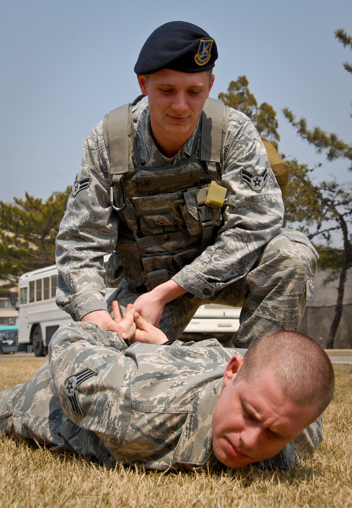 KUNSAN AIR BASE, Republic of Korea -- Airman 1st Class Adam Mathias, 8th Security Forces Squadron pass and registration clerk and first-term Airman, “arrests” Senior Airman Dwight Corbett, 8th SFS ration control clerk, here March 31 as they practice proper procedures in preparation for the upcoming Operational Readiness Inspection slated for the week of April 4. (U.S. Air Force photo/Senior Airman Benjamin Stratton)