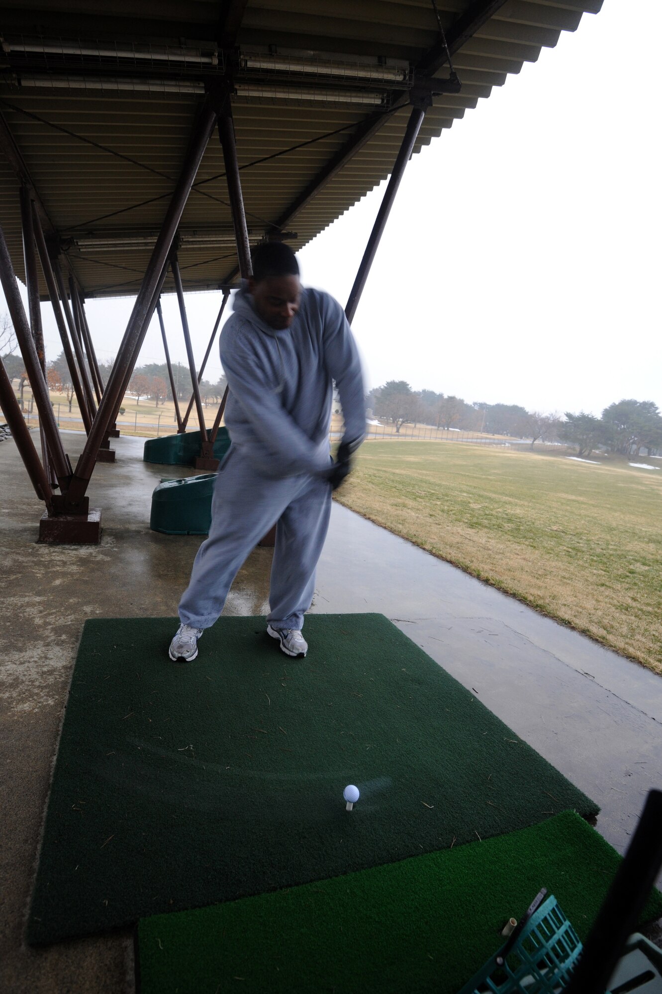 MISAWA AIR BASE, Japan -- Technical Sgt. Chris Draper, Unit training manager for the 301st Intelligence Squadron, takes time to relax on the Misawa driving range March 30.  The Misawa driving range and golf course was closed over the winter season and remained closed after the earth quake and tsunami disaster.  The driving range returns to normal hours of operation as Misawa Air Base continues to restore the base to normal operations. (U.S. Air Force photo by Staff Sgt. April Quintanilla\Released)