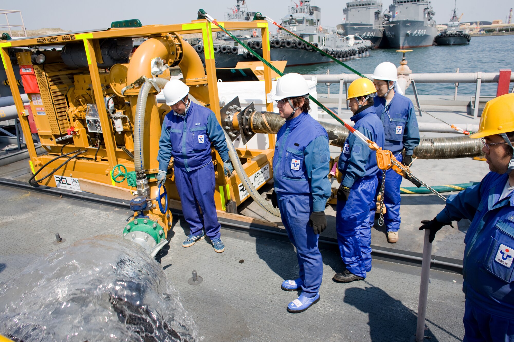 ONAHAMA, Japan -- Contractors from the Tokyo Electric Power Company practice emergency action drills near the Fukushima nuclear power plant March 29, 2011. The U.S. government provided water pumps and two barges to TEPCO to allow freshwater to be sprayed on the reactor. Japan Maritime Self-Defense Force vessels towed the barges from Yokosuka to the site.  Eight Yokota Airmen designed and created necessary adapters, pressure valves and other pieces of equipment to modify the pumps for the mission. (U.S. Air Force photo/Osakabe Yasuo)