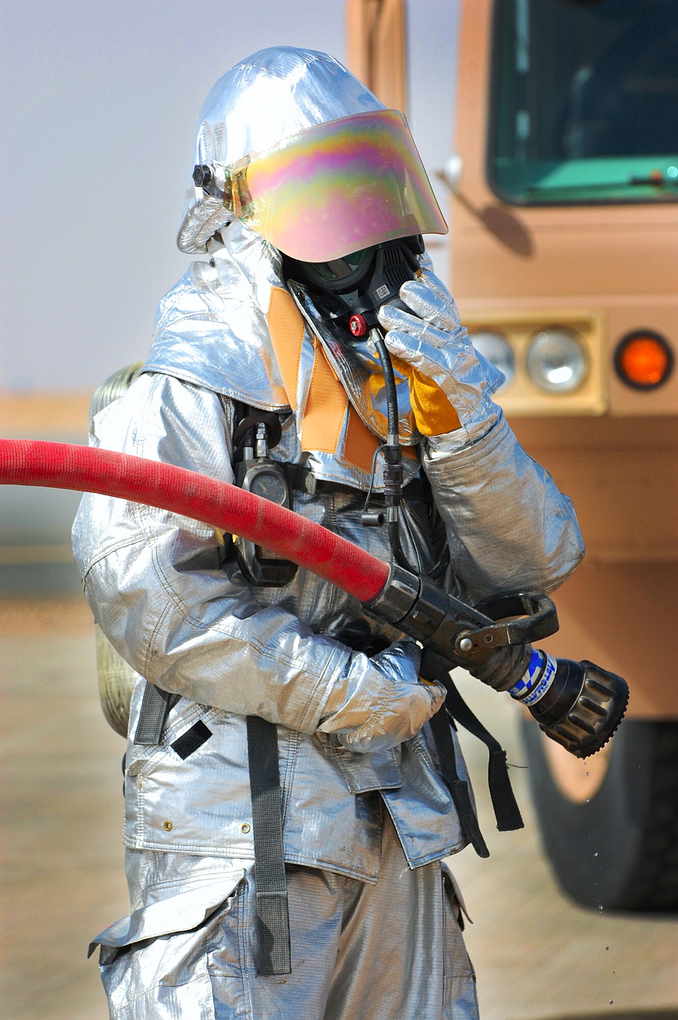 Senior Airman Dan DeMay holds the rapid intervention line while preparing for entry to a live fire training exercise in Southwest Asia, March 26. Firefighters must complete two live fire training exercises a year. Airmen DeMay is a firefighter with the 386th Expeditionary Civil Engineer Squadron. (U.S. Air Force photo by Senior Airman Cynthia Spalding)
