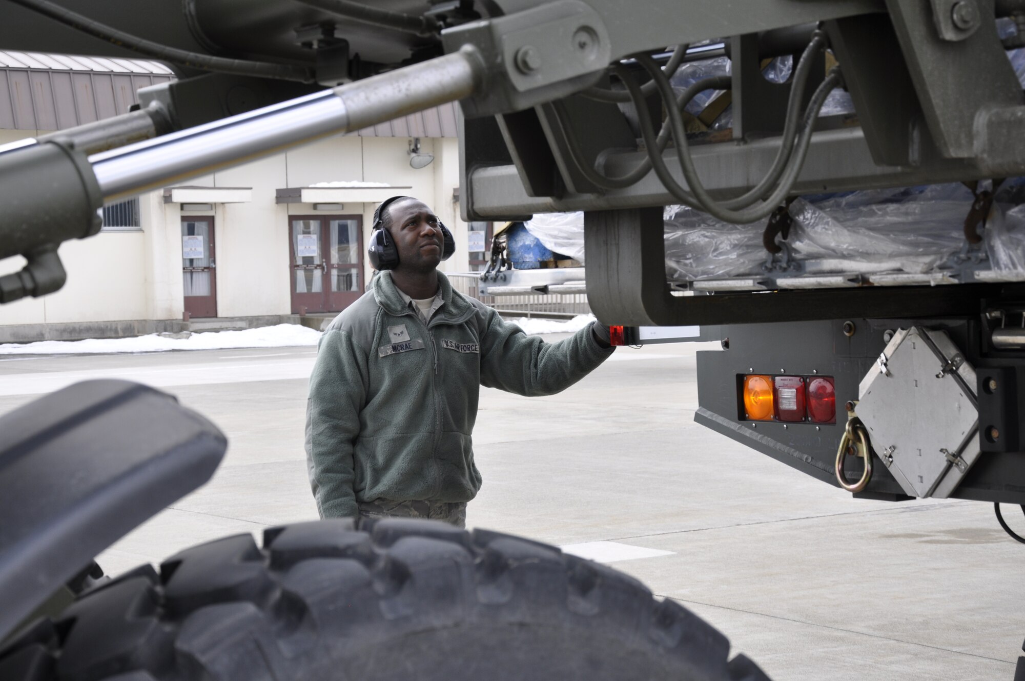 MISAWA AIR BASE, Japan -- Airman 1st Class Corinthians McRae, deployed from the 621st Contingency Response Wing at McGuire Air Force Base, N.J., monitors a forklift unloading cargo from a U.S. Air Force C-17 Globemaster III, here March 30. Airman McRae and others from the 621st CRW deployed to Misawa to assist with Operation Tomodachi and the earthquake recovery efforts. (U.S. Air Force photo by Senior Airman Joe McFadden/Released)