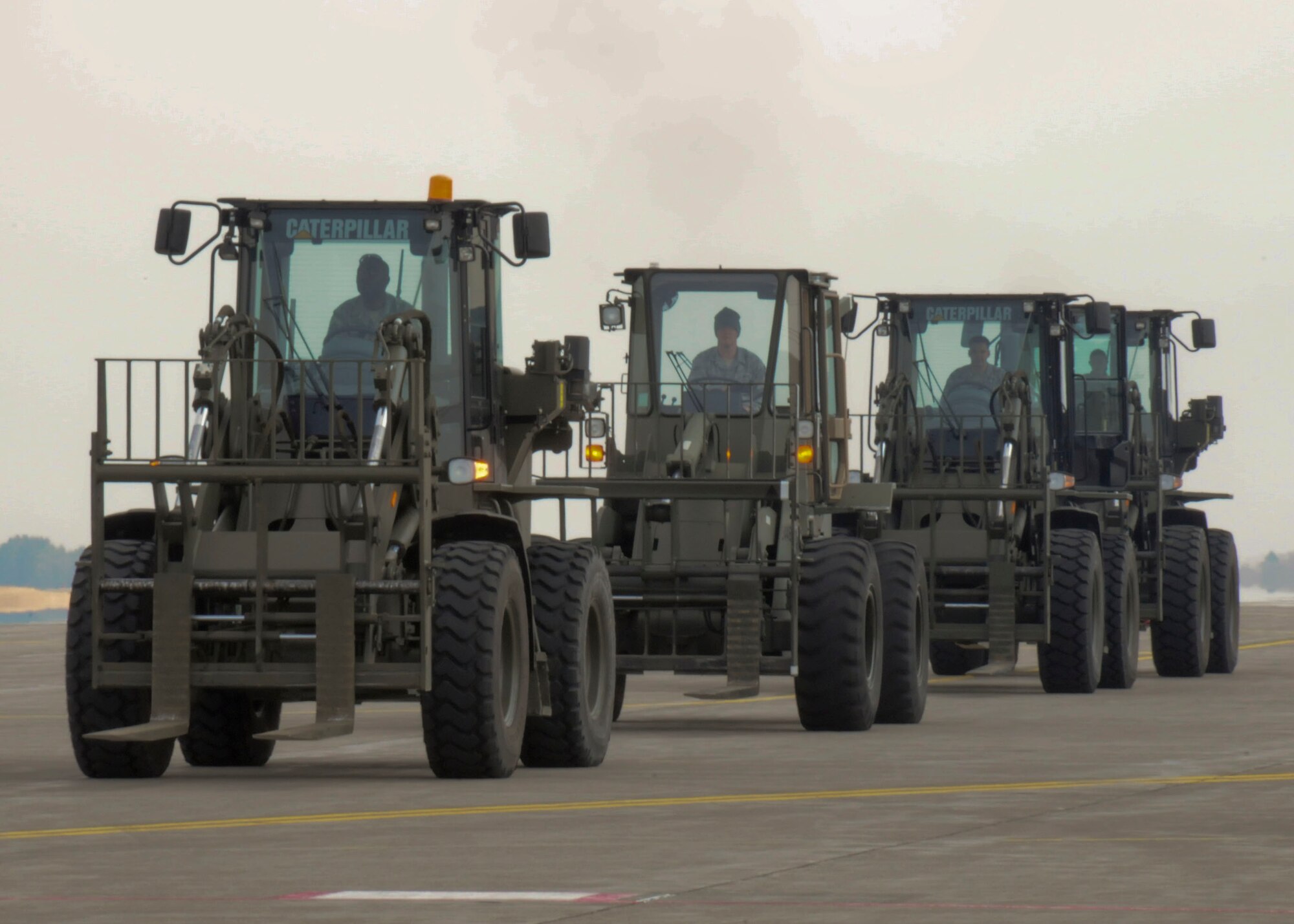 MISAWA AIR BASE, Japan -- Forklifts line the flightline here waiting to offload cargo March 30. Since Operation Tomodachi kicked-off, Misawa Air Base has received more than a million pounds of cargo in support of earthquake and tsunami relief operations. (U.S. Air Force photo by Staff Sgt. Rachel Martinez/Released) 