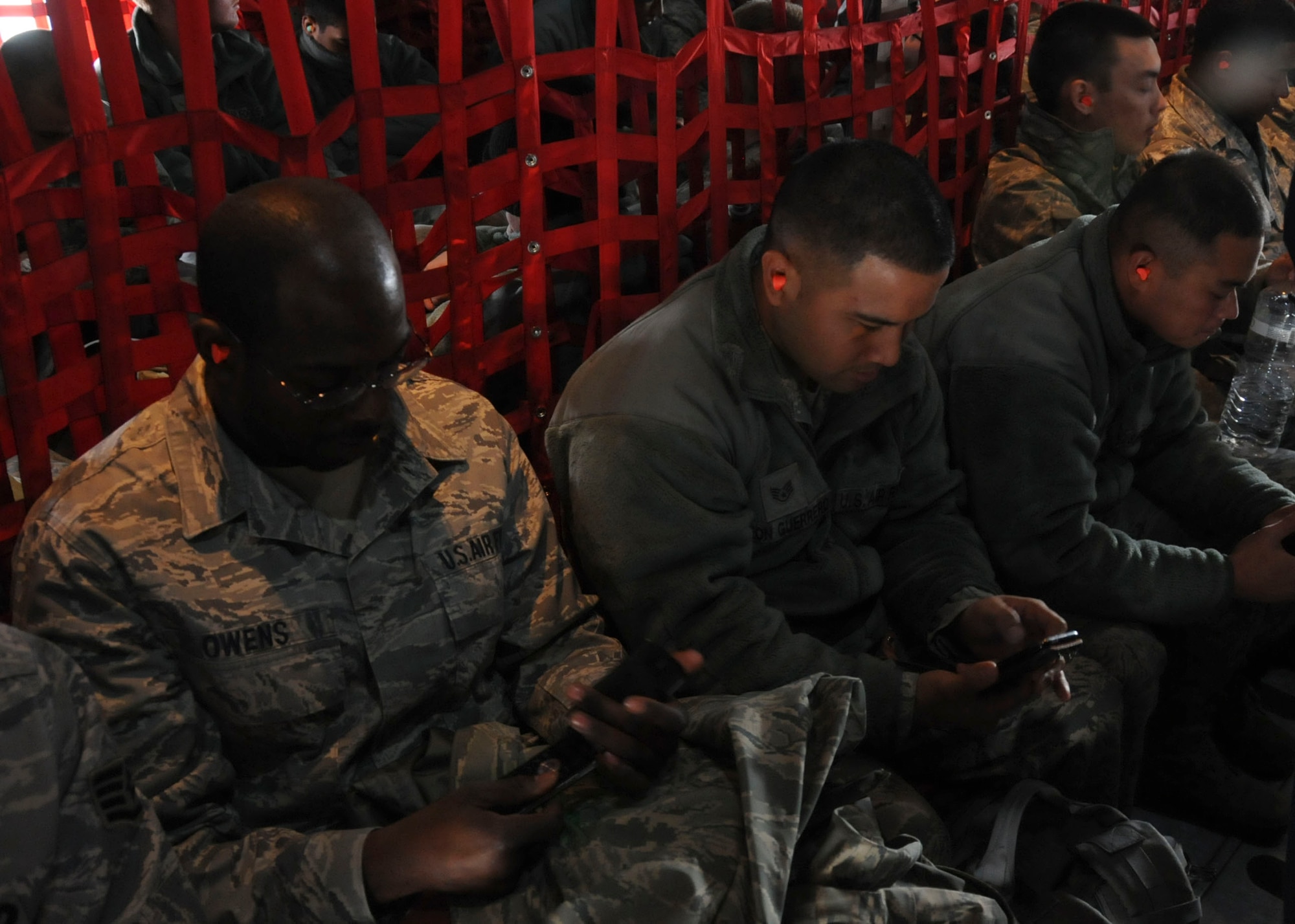 MISAWA AIR BASE, Japan -- Airmen from the 18th Civil Engineer Squadron, based in Kadena Air Base, wait to go home on a U.S. Air Force C-130 Hercules here March 30. Electricians, power production specialists and HVAC technicians from Pacific Air Forces bases were brought in to Misawa to help restore the base to pre-earthquake operations. While some recovery operations still remain, 42 civil engineer Airmen have redeployed, leaving approximately 20 augmentee Airmen to assist with remaining efforts. (U.S. Air Force photo by Staff Sgt. Rachel Martinez/Released)