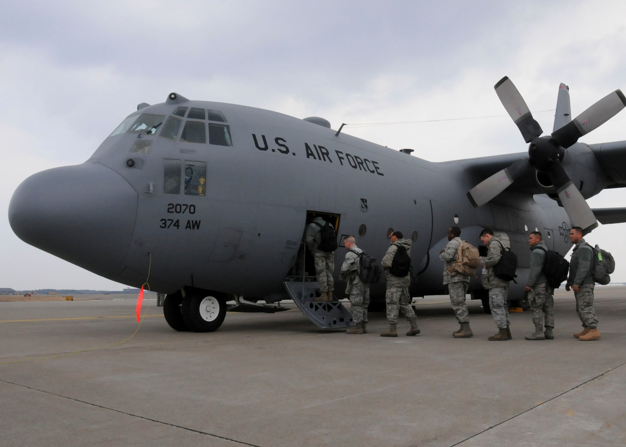 MISAWA AIR BASE, Japan -- Airmen from the 18th Civil Engineer Squadron based out of Kadena Air Base, Japan, load a U.S. Air Force C-130 Hercules on the flightline here March 30. The Airmen deployed to Misawa for more than two weeks to help the base recover from the March 11 earthquake which took out power and caused minor facility damage. Approximately 20 civil engineers from Pacific Air Forces bases still remain at Misawa to help with the remainder of recovery efforts. (U.S. Air Force photo by Staff Sgt. Rachel Martinez/Released)