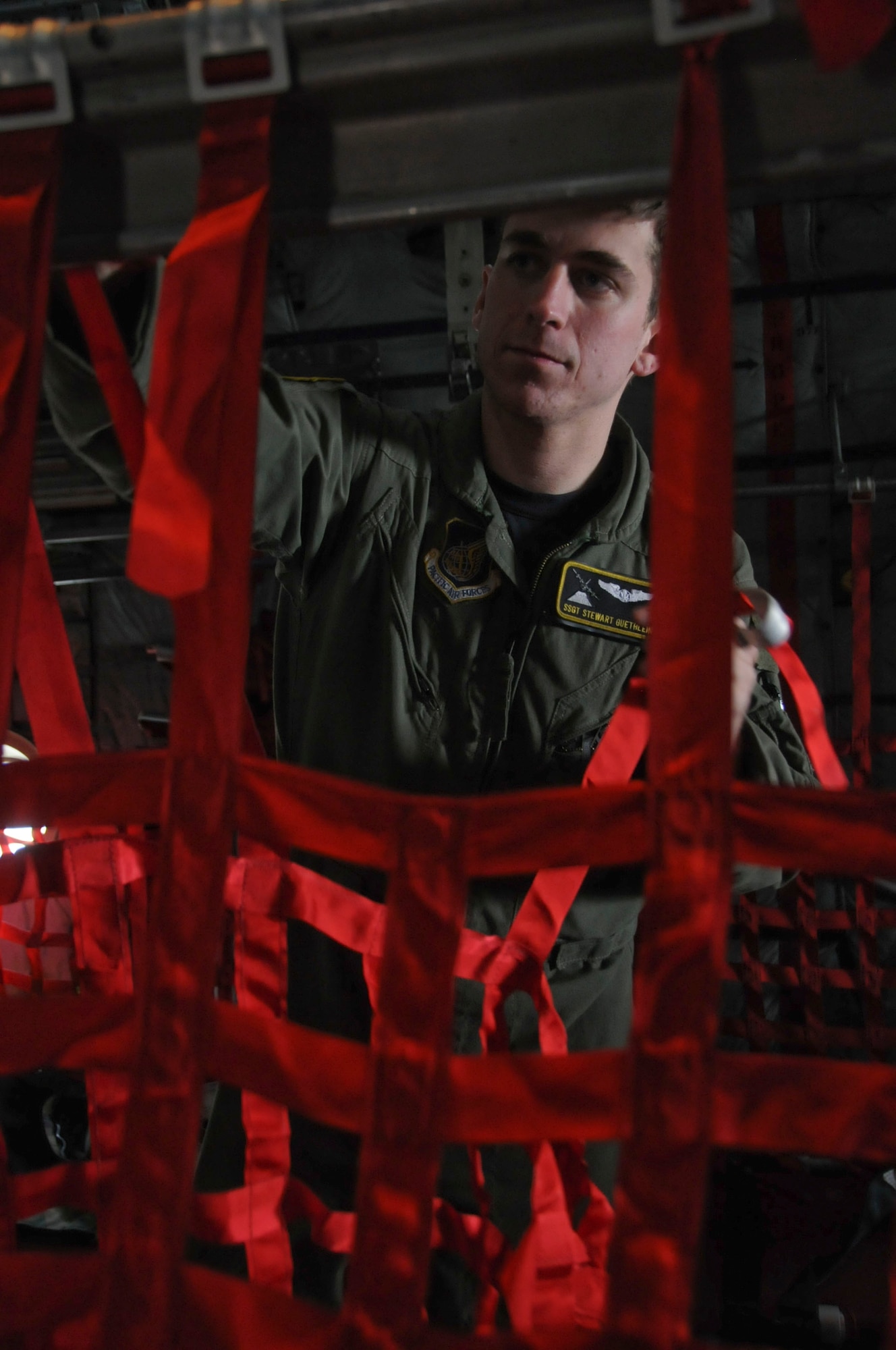 MISAWA AIR BASE, Japan -- Staff Sgt. Stewart Guethlein, a loadmaster with the 36th Airlift Squadron from Yokota Air Base, sets up seats inside a U.S. Air Force C-130 Hercules here March 30. After dropping off some cargo at Misawa, the C-130 flew 42 civil engineers back home to Kadena Air Base. The engineers were part of request for forces brought in to help Misawa recover from the March 11 earthquake. (U.S. Air Force photo by Staff Sgt. Rachel Martinez/Released)