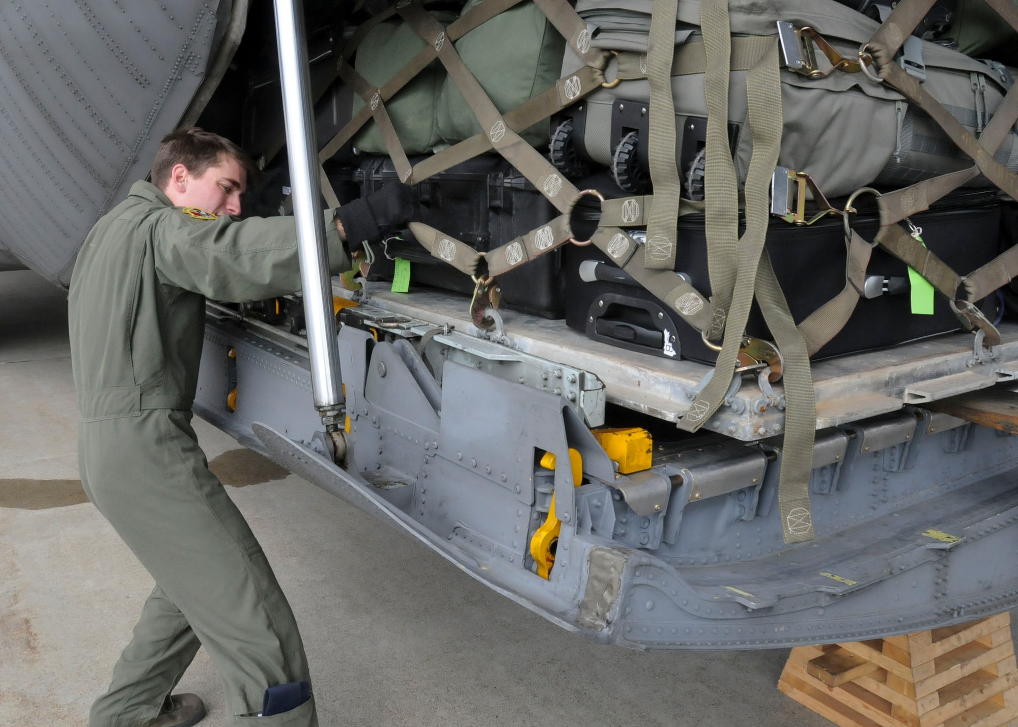 MISAWA AIR BASE, Japan -- Staff Sgt. Stewart Guethlein, a loadmaster with the 36th Airlift Squadron from Yokota Air Base, loads a baggage pallet onto a U.S. Air Force C-130 Hercules here March 30. The baggage belonged to a group of 42 civil engineers who redeployed to Kadena Air Base after augmenting the 35th Civil Engineer Squadron in the immediate aftermath of the March 11 earthquake. (U.S. Air Force photo by Staff Sgt. Rachel Martinez/Released)